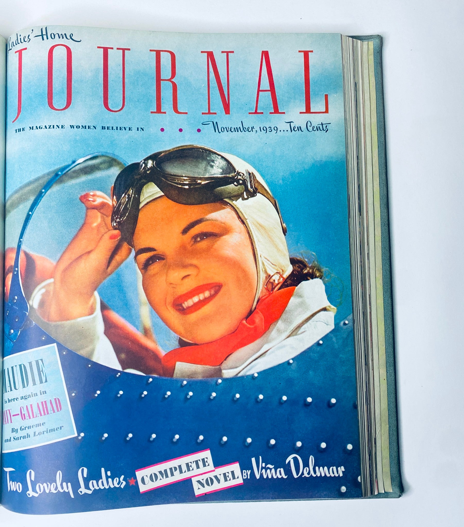 Cover of Ladies' Home Journal November 1939 featuring a woman in aviator goggles, showcasing the era's fashion. This image is part of the bound magazine collection from 1939.