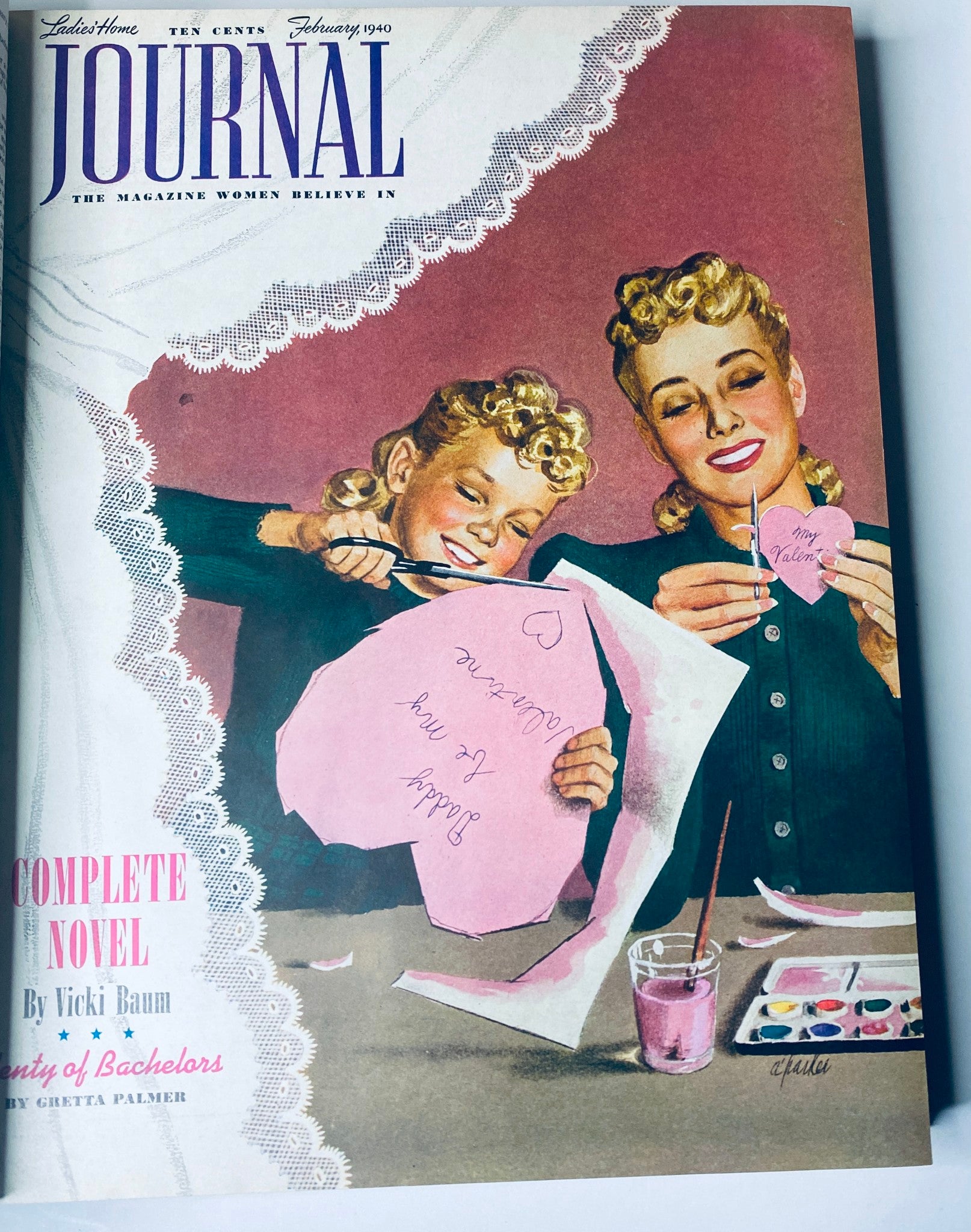 Cover of Ladies' Home Journal February 1940, depicting a mother and daughter crafting Valentine's Day cards, illustrating family activities in a nostalgic magazine format.