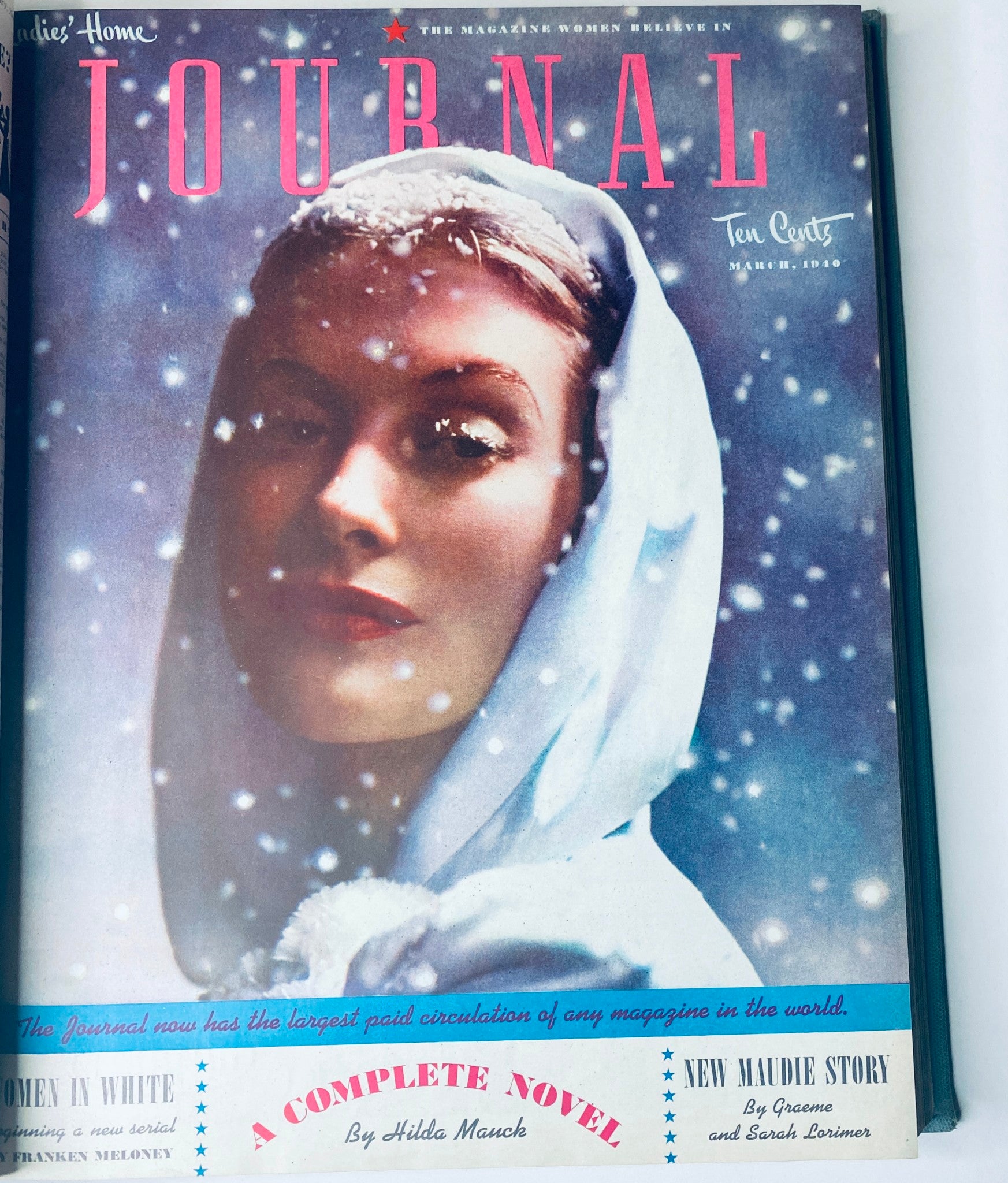 Cover of Ladies' Home Journal March 1940, featuring a snow-covered woman in a winter setting, displaying classic 1940s fashion trends in vintage magazines.