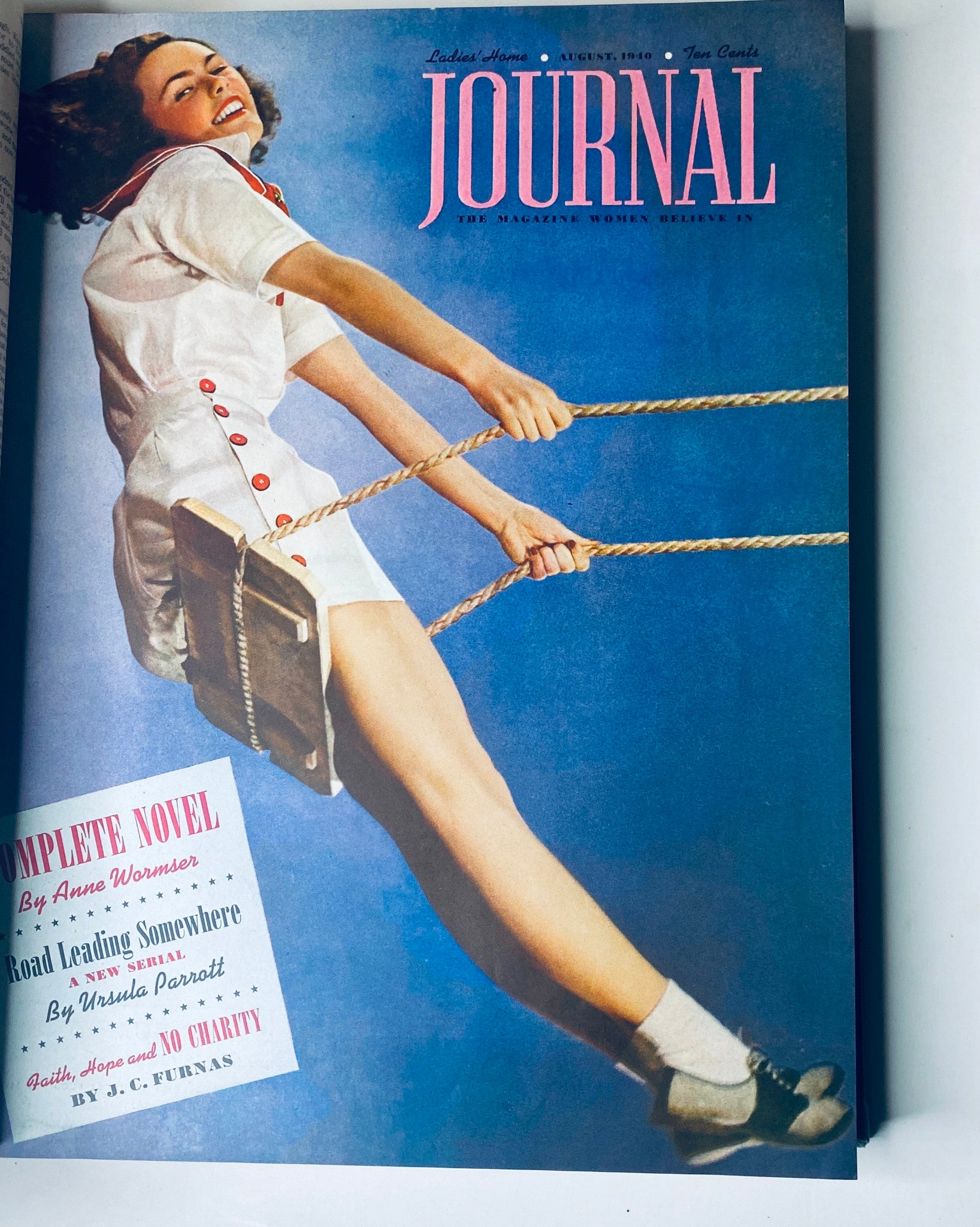 Ladies' Home Journal Bound Magazine 1940 - Cover of the August issue, displaying a woman swinging joyfully on a playground swing, emphasizing fun and adventure.
