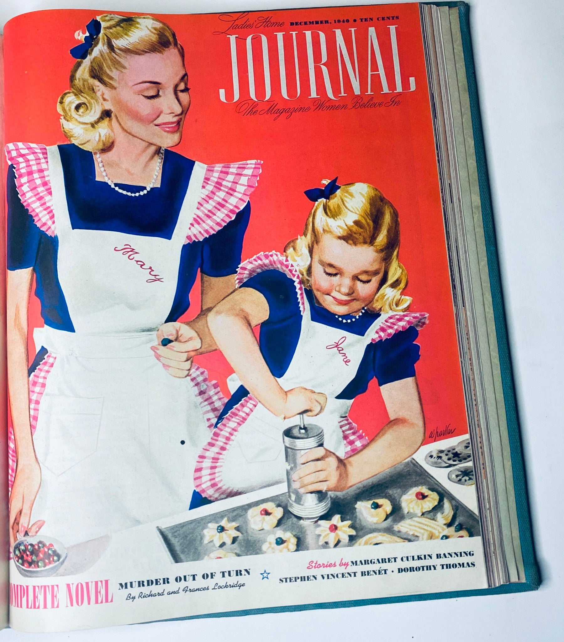 Cover of the Ladies' Home Journal December 1940 magazine, featuring a vibrant illustration of two women, one adult and one child, in aprons. They are engaged in baking with cookies on a tray, highlighting fashion and home living of the time.