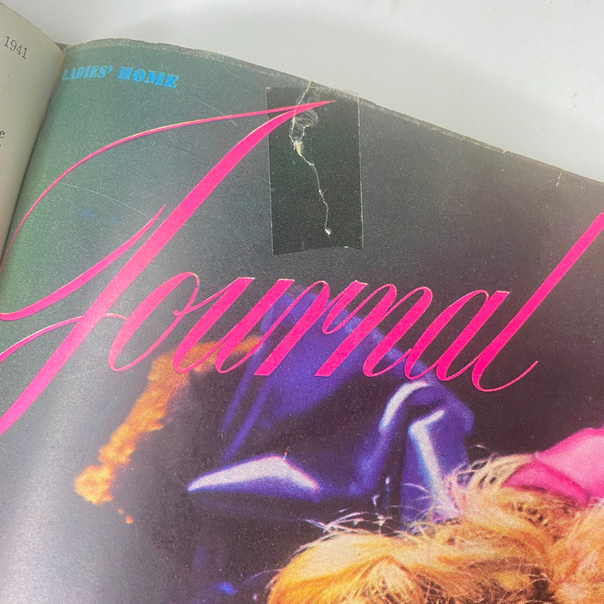 Close-up of the Ladies' Home Journal Bound Magazine 1941 cover, displaying the magazine title in pink and highlighting wear on the cover.