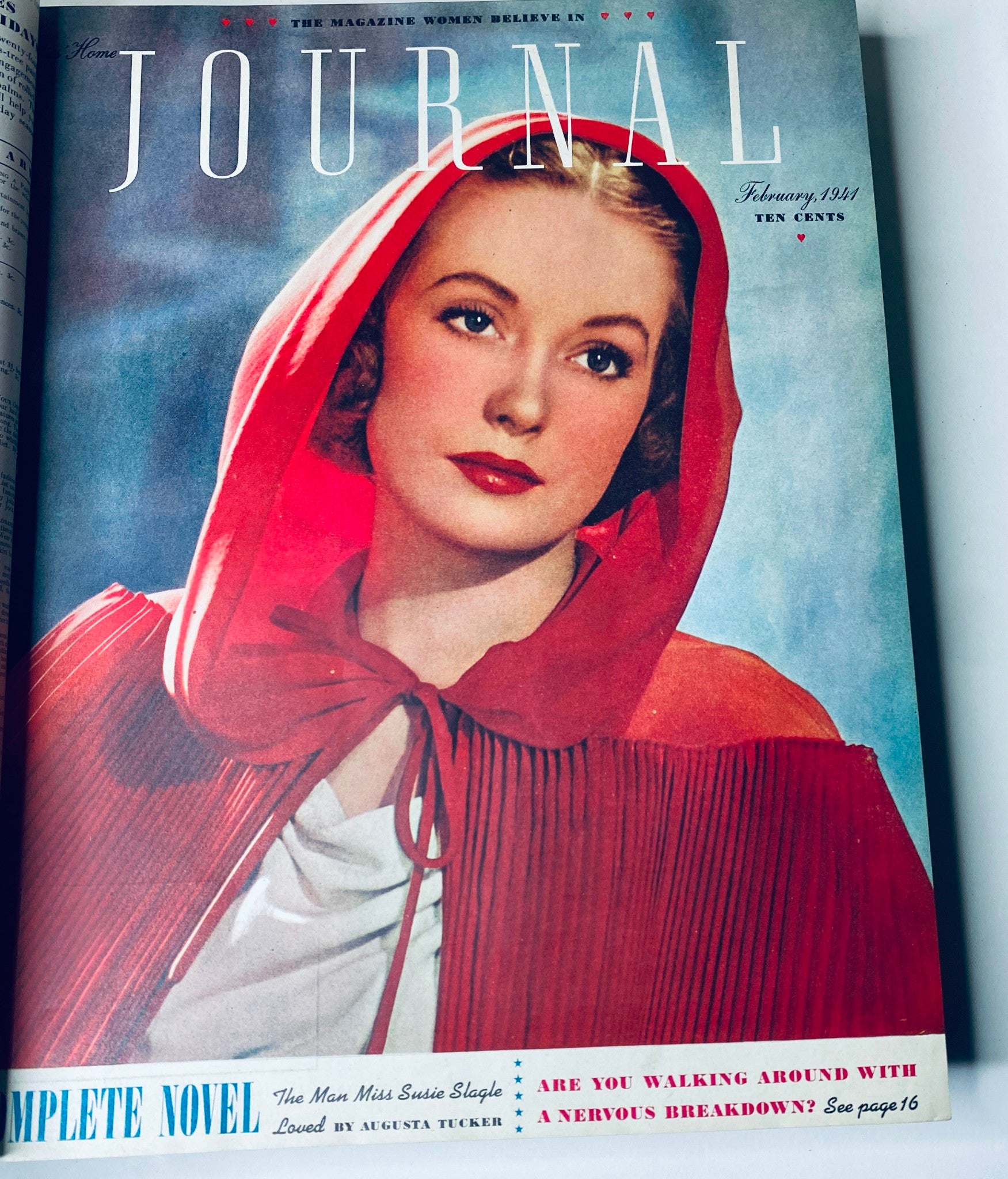 Cover of the February 1941 edition of Ladies' Home Journal showcasing a woman in a red hood with a striking portrait.