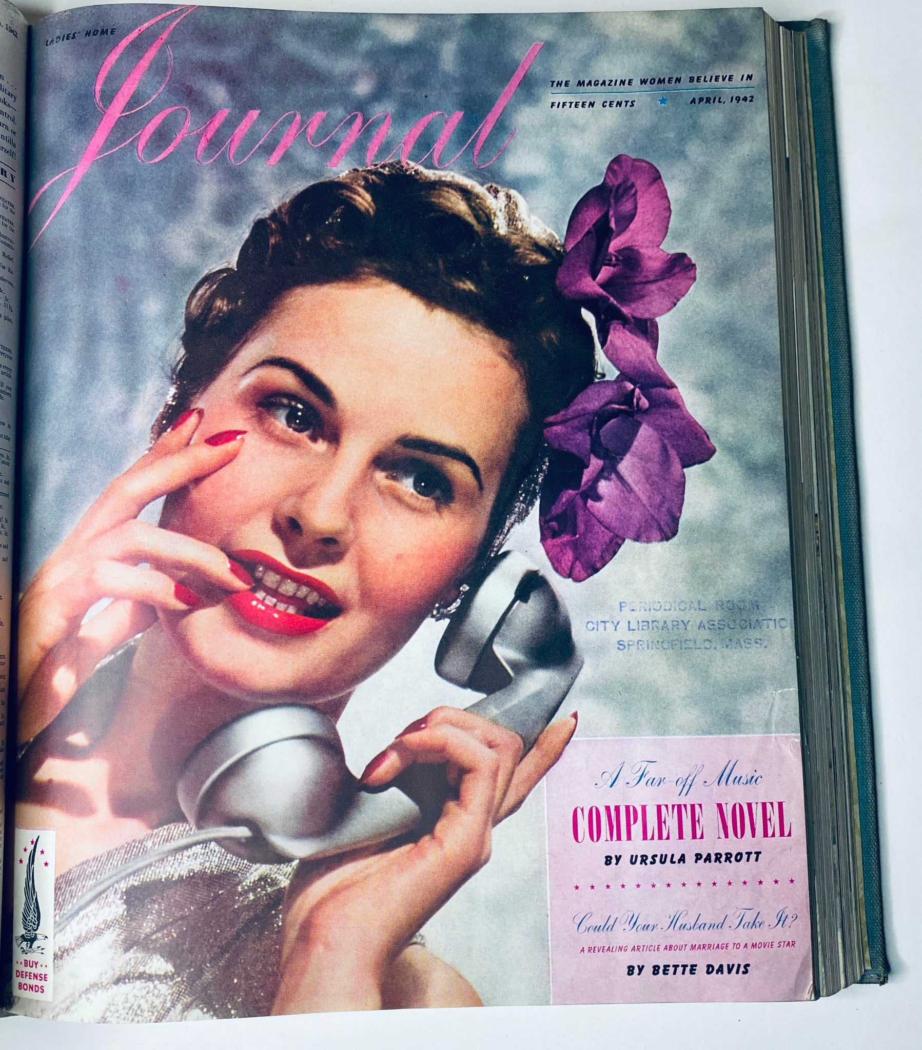 Ladies' Home Journal April 1942 magazine cover highlighting a woman with a phone and flowers, representing the style and charm of 1940s fashion.