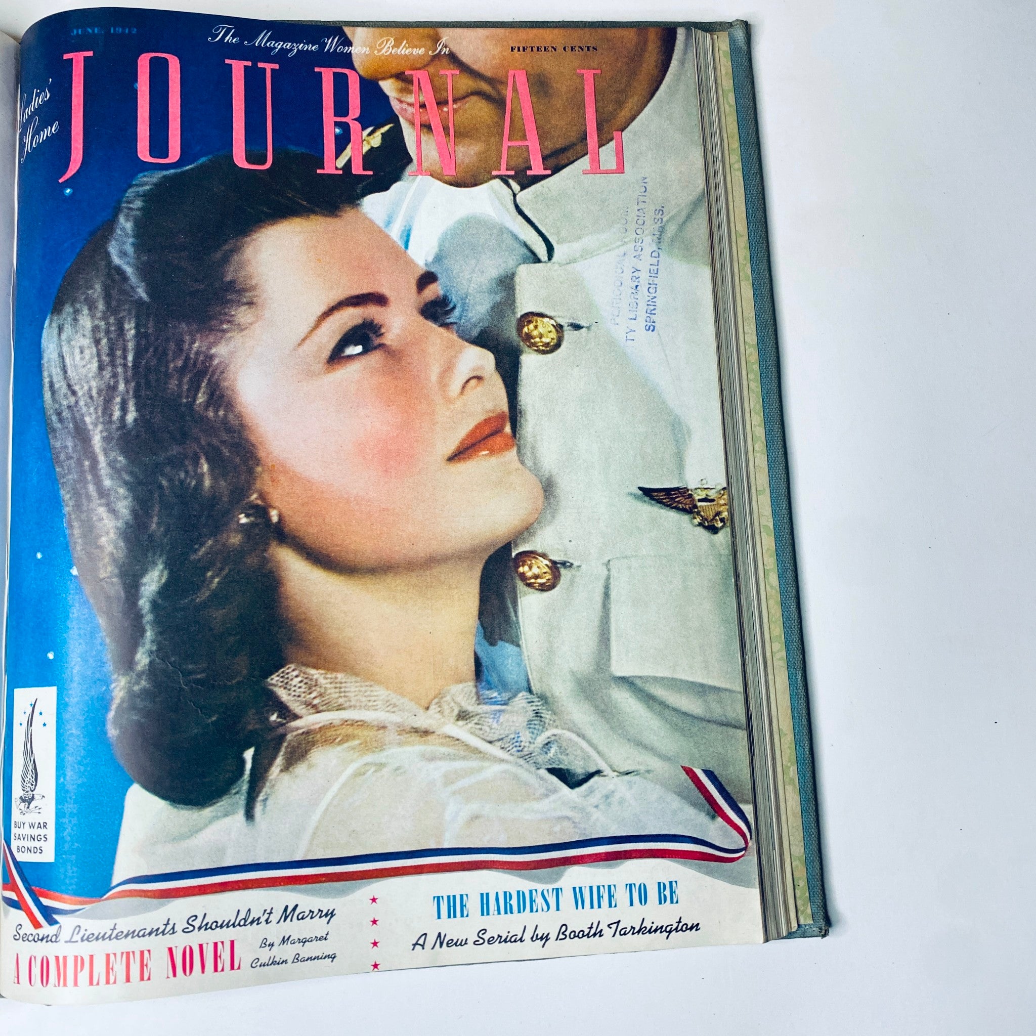 Ladies' Home Journal June 1942 magazine cover featuring a woman gazing up at a military man, capturing the romantic ideals of the time period.