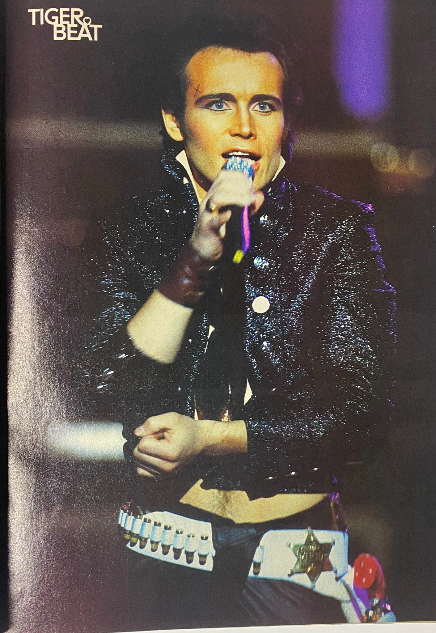 Performance image of Rick Springfield in the March 1984 issue of Tiger Beat Magazine, showcasing the glam rock style of the early 80s.