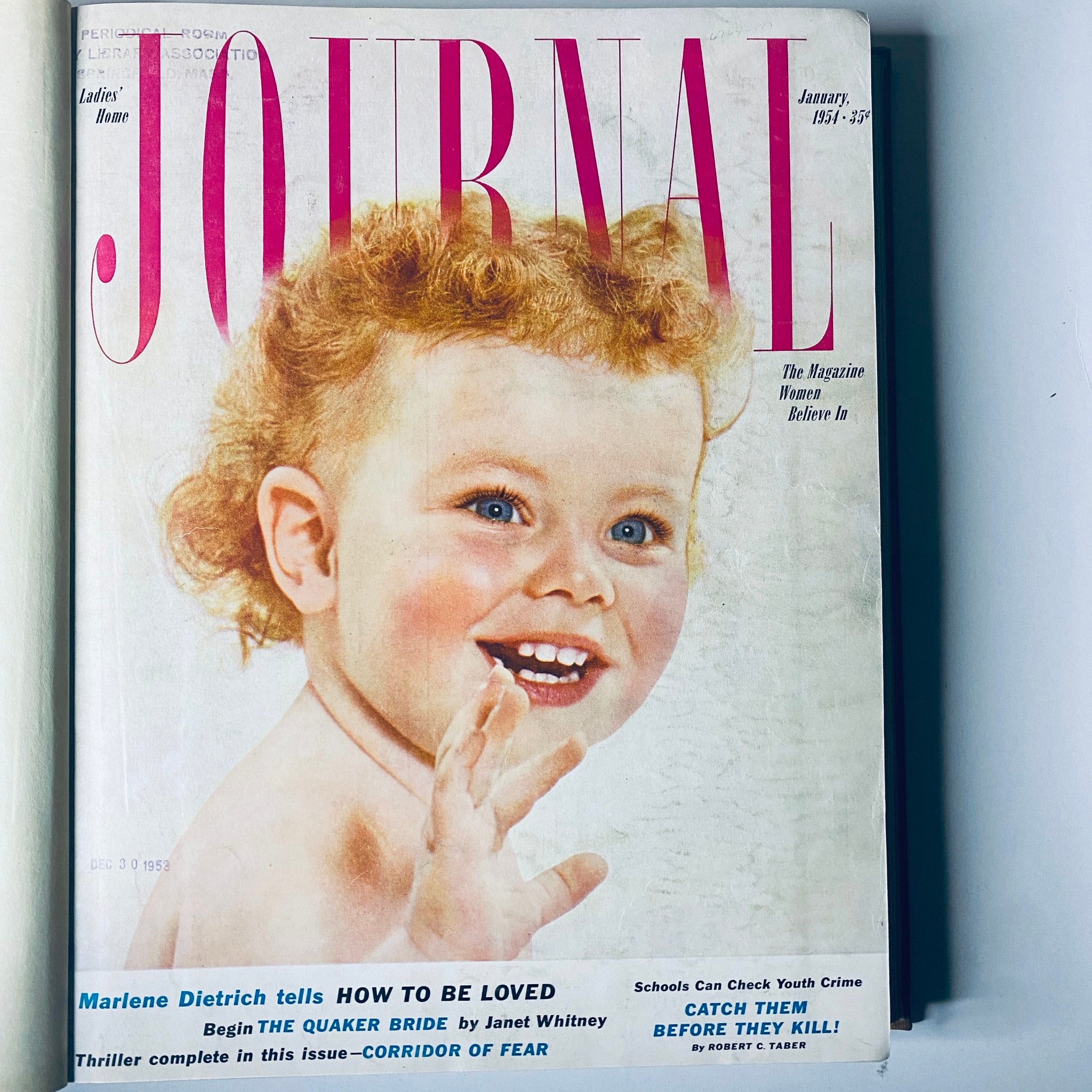 Ladies' Home Journal January 1954 cover featuring a cheerful child with curly hair and vibrant colors.