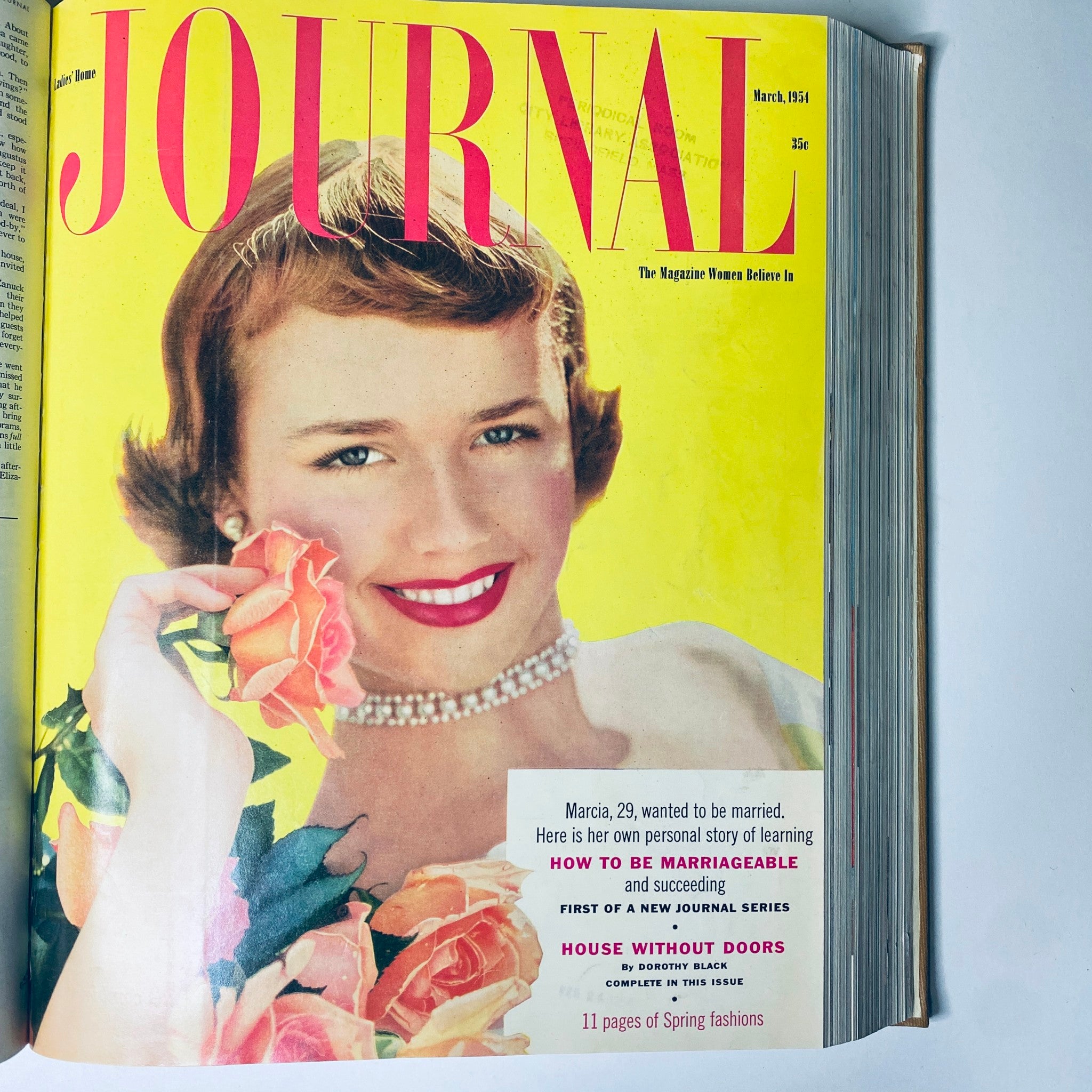 Ladies' Home Journal March 1954 cover highlighting a smiling woman with roses, representing 1950s fashion.
