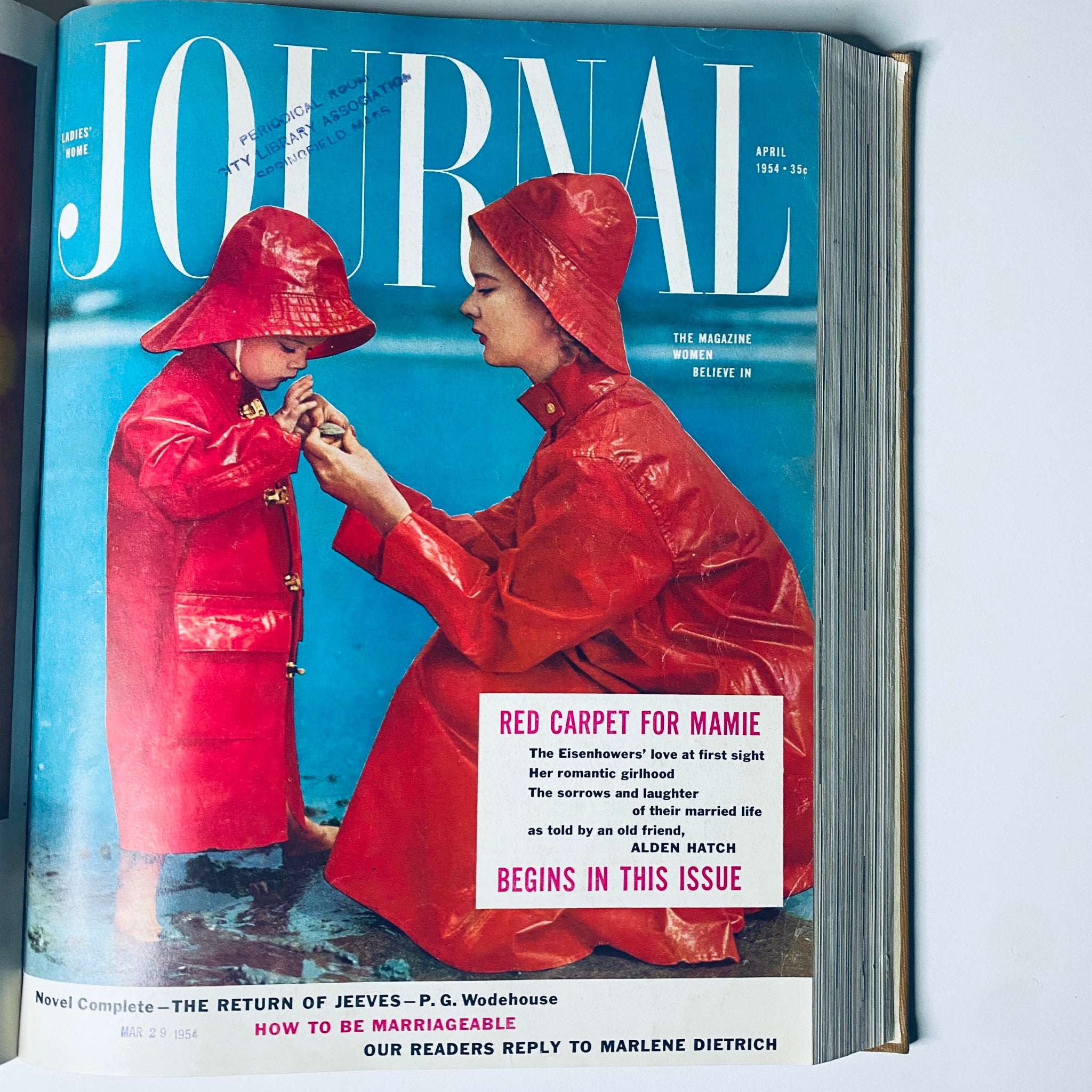 Ladies' Home Journal April 1954 cover depicting a mother and child in raincoats, illustrating family life in the 1950s.