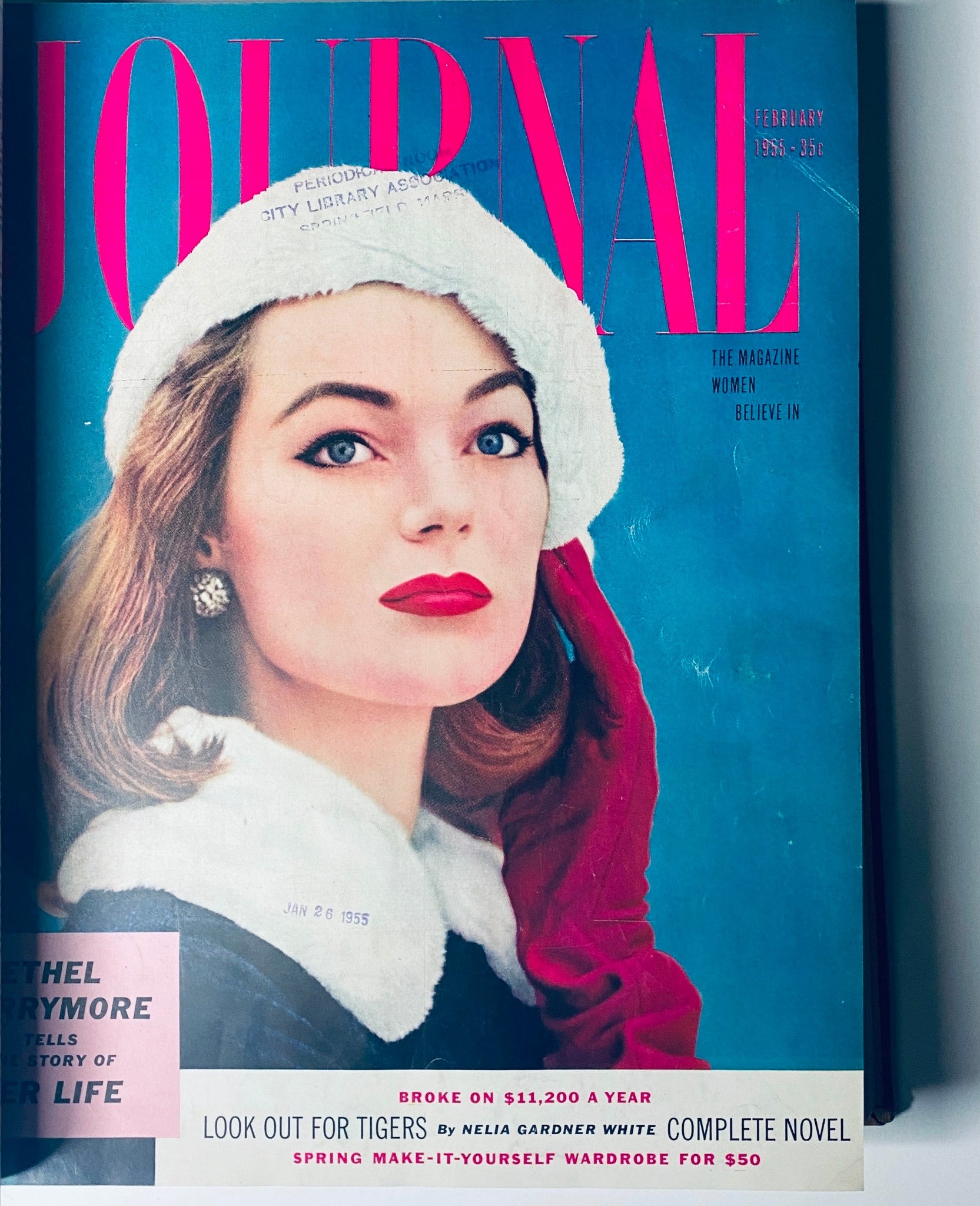 February 1955 cover of Ladies' Home Journal featuring a woman in a winter hat, showcasing vintage makeup and hairstyle trends from mid-20th century America.