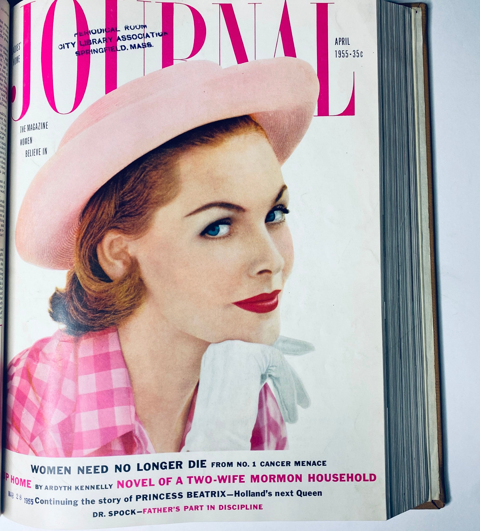 April 1955 cover of Ladies' Home Journal displaying a woman in a pink hat, reflecting the fashion and cosmetic styles popular among women in the 1950s.
