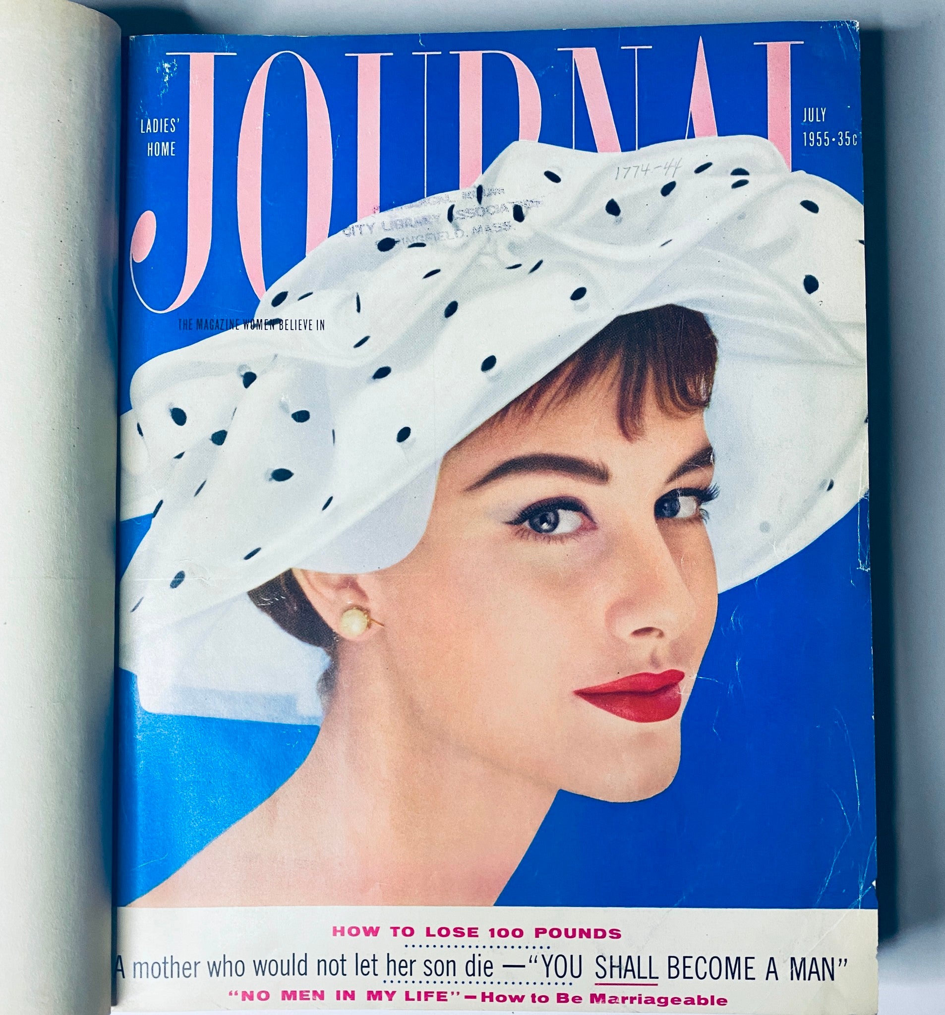 Cover of Ladies' Home Journal July 1955 magazine featuring a woman wearing a stylish white polka dot hat, highlighting topics like weight loss and relationship advice.