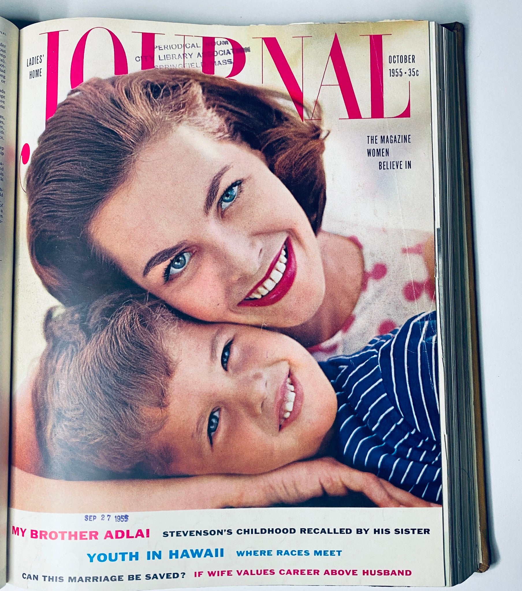 Cover of Ladies' Home Journal October 1955 magazine displaying a mother with her child, emphasizing topics on family and cultural issues of the time.