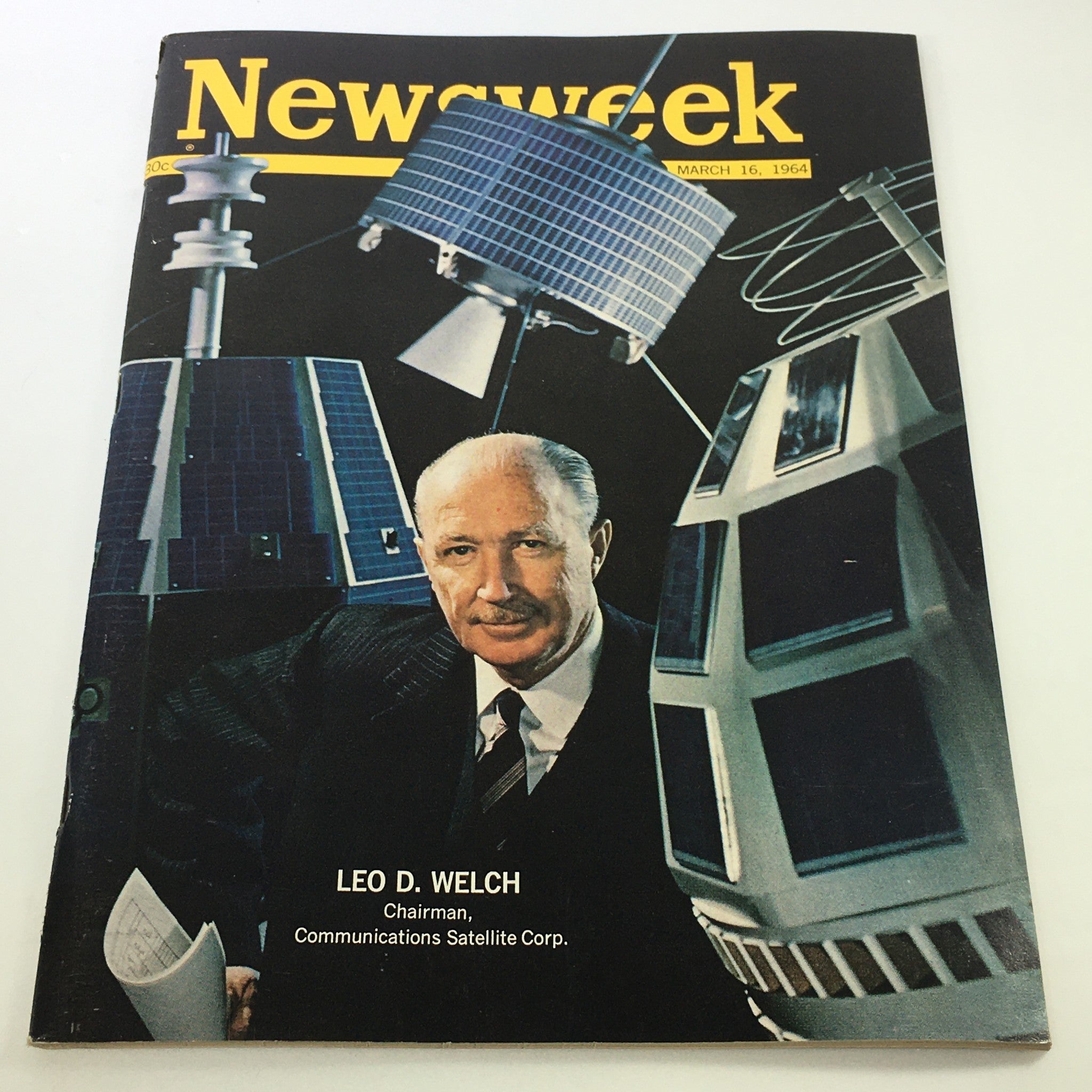 VTG Newsweek Magazine March 16, 1964 featuring Chairman Leo D. Welch on the cover, surrounded by illustrations of communications satellites, showcasing a significant moment in 1960s media history.