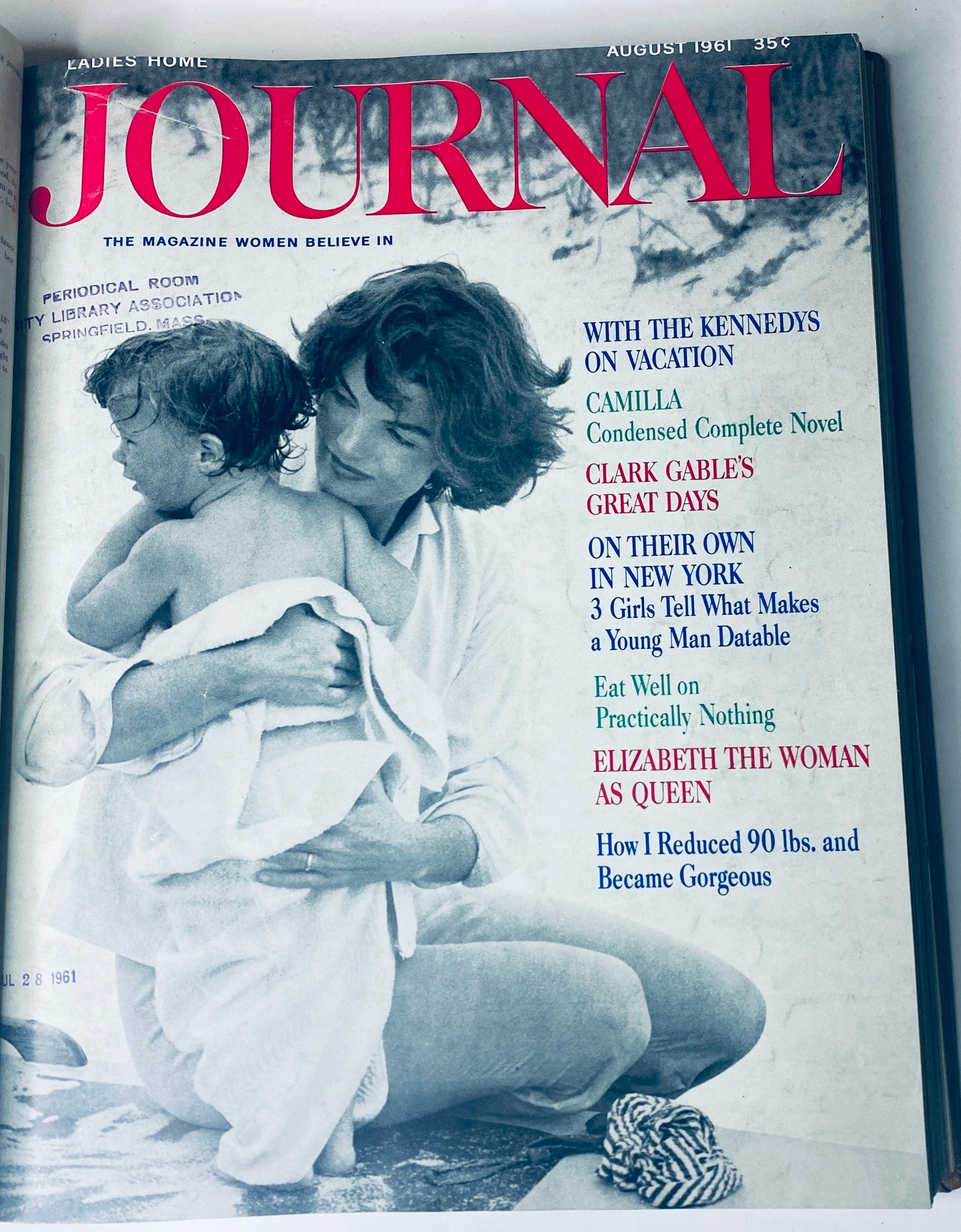 Ladies' Home Journal Bound Magazine, August 1961 issue showcasing a tender moment of a mother holding her child on the beach.