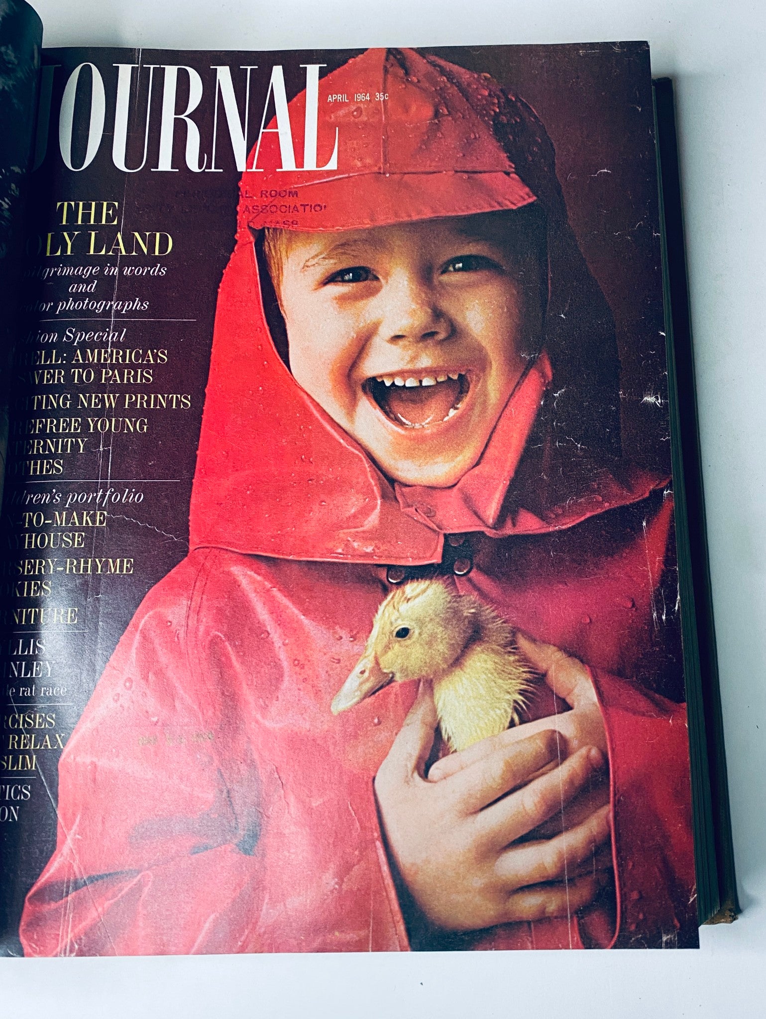 Cover of Ladies' Home Journal April 1964 showcasing a smiling boy in a raincoat holding a duckling, emphasizing family-friendly content.