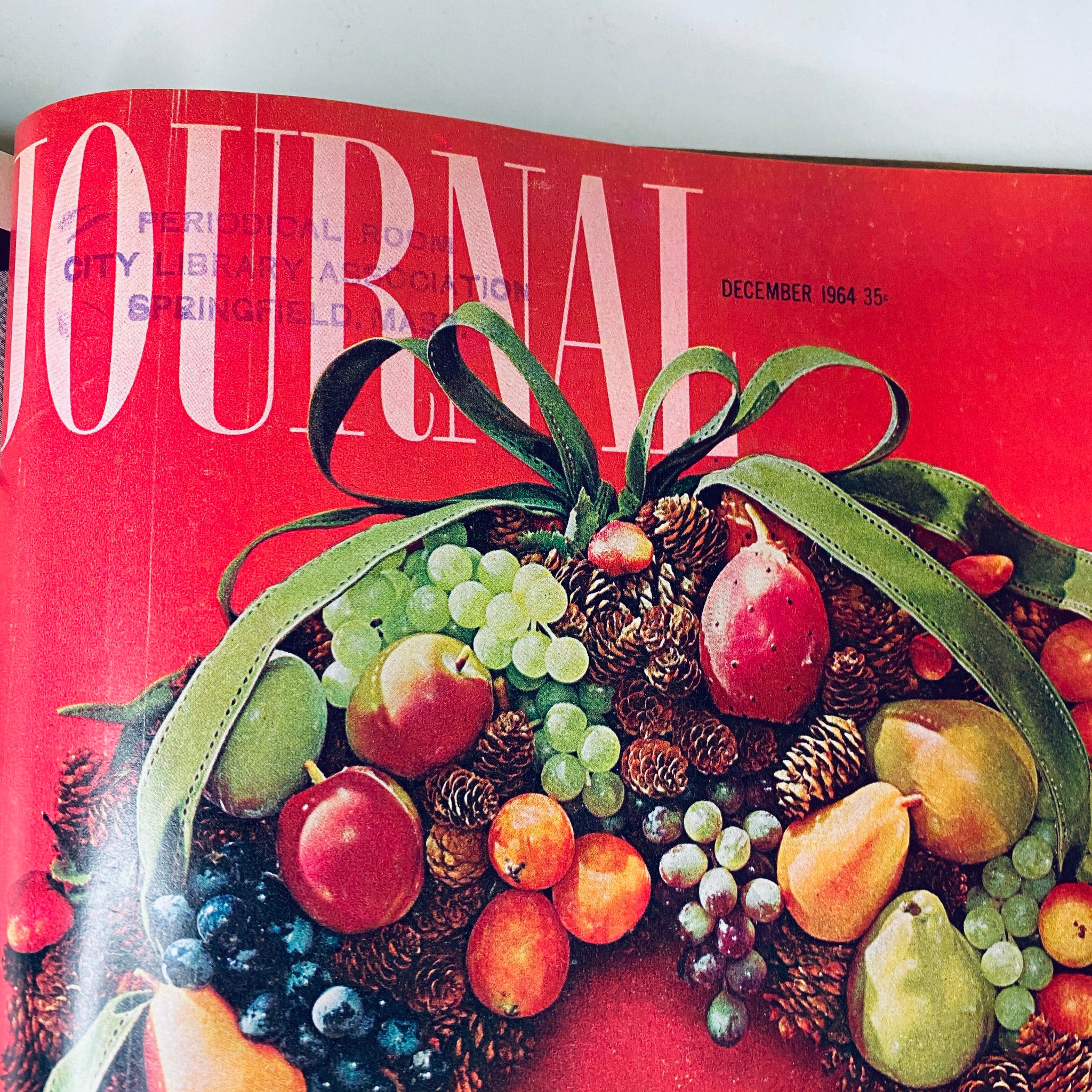 Cover of Ladies' Home Journal magazine from December 1964 featuring a festive arrangement of fruits and pinecones, highlighting vintage style and seasonal decor.