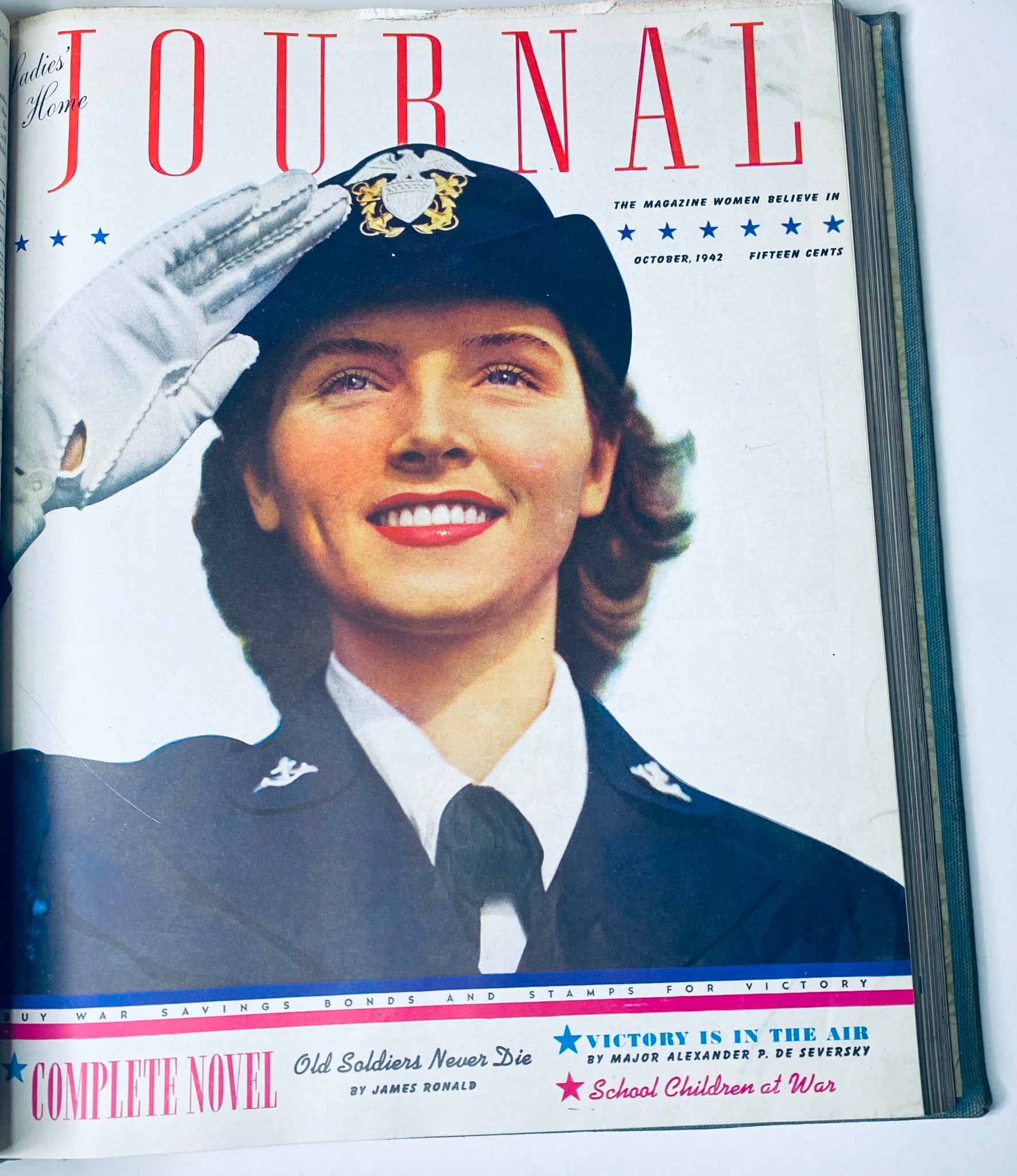 Cover of Ladies' Home Journal Library Bound Magazine 1942, depicting a woman in military uniform saluting, emphasizing women's contributions during World War II.