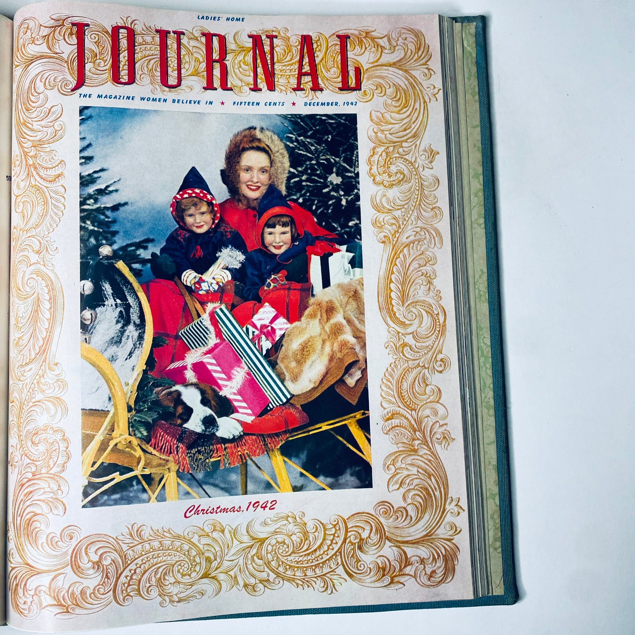 Ladies' Home Journal Library Bound Magazine 1942 - December cover showcasing a woman with two children in a snowy scene celebrating Christmas.