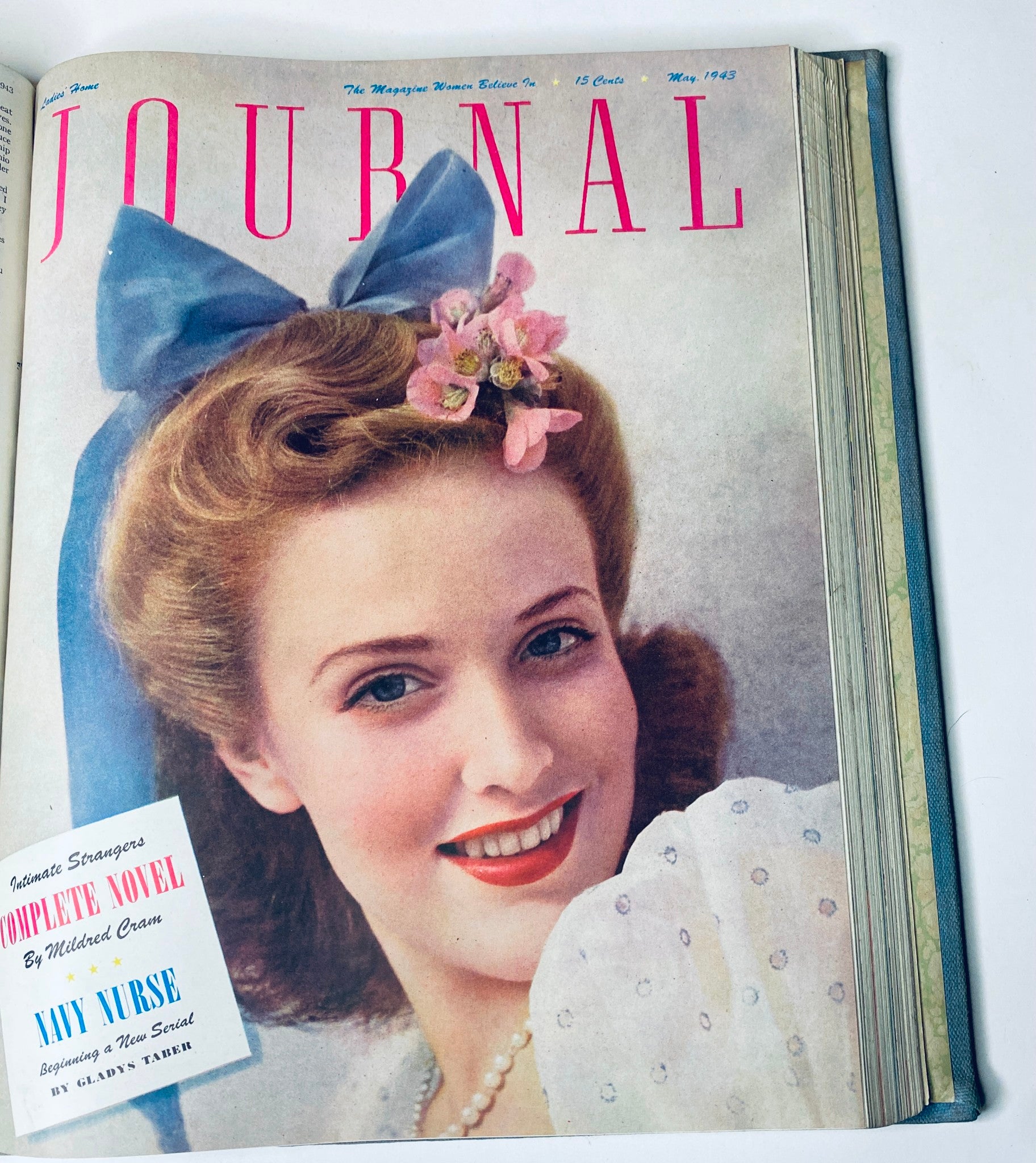 Ladies' Home Journal Library Bound Magazine 1943 Full Year January - December, May 1943 cover showcasing a woman with a blue bow and floral hair decoration.