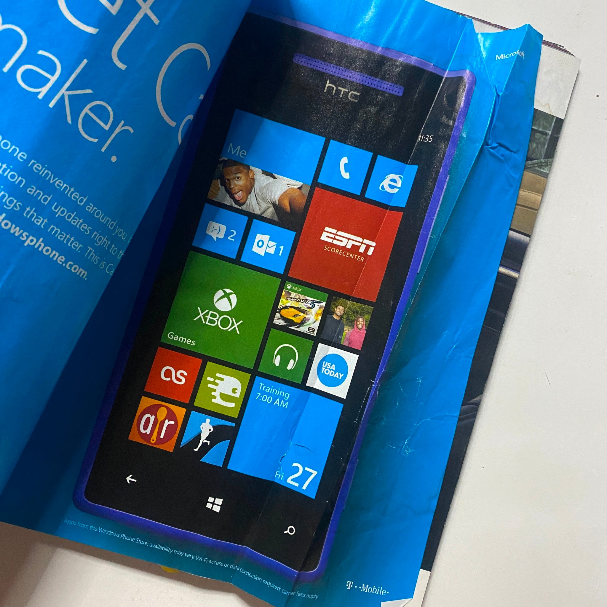 Inside page of Men's Health Magazine February 2013 showcasing a digital advertisement for the HTC smartphone with Windows Phone interface.
