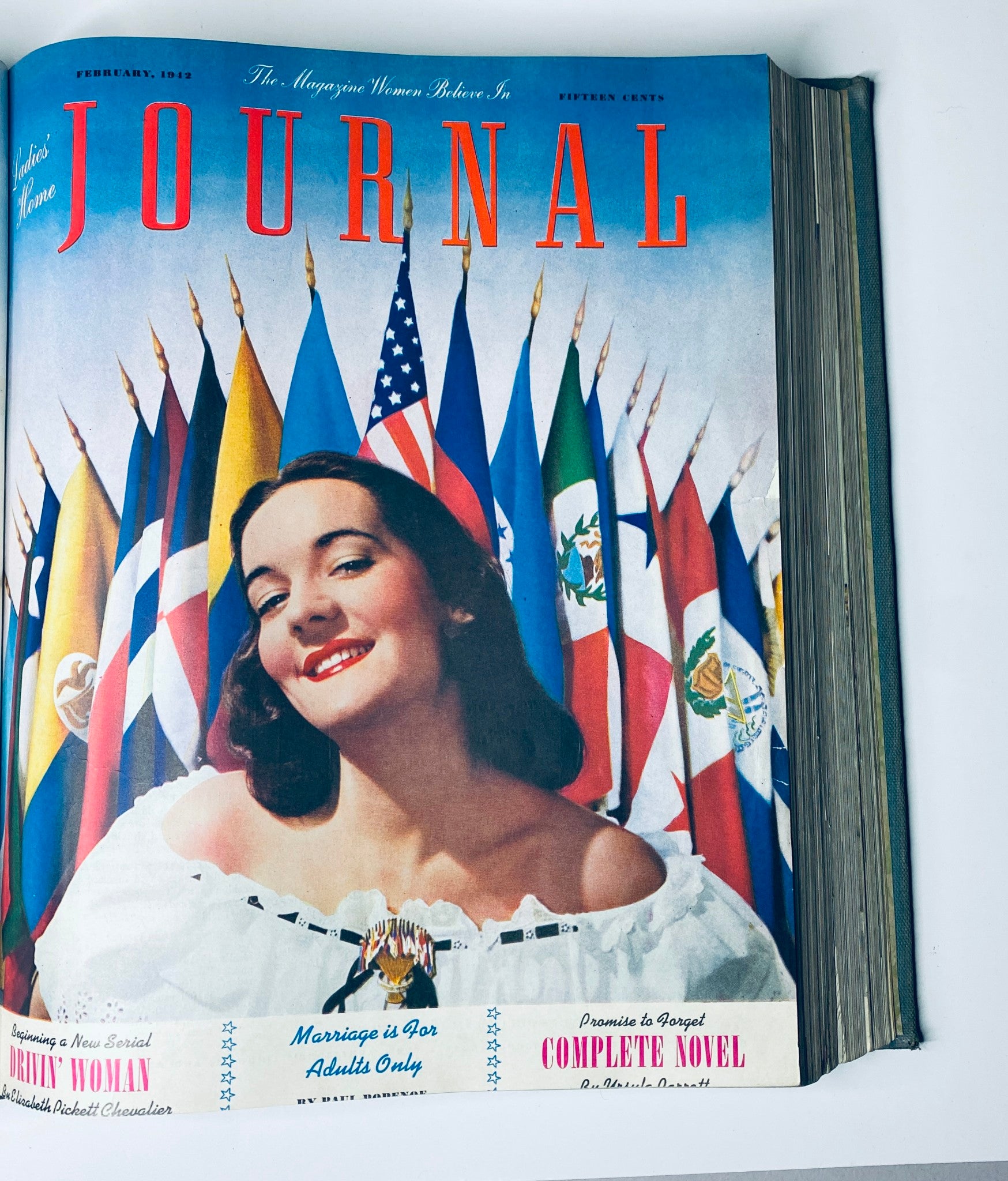 Ladies' Home Journal Library Bound Magazine 1942 - February cover displaying a smiling woman in traditional attire with flags in the background.