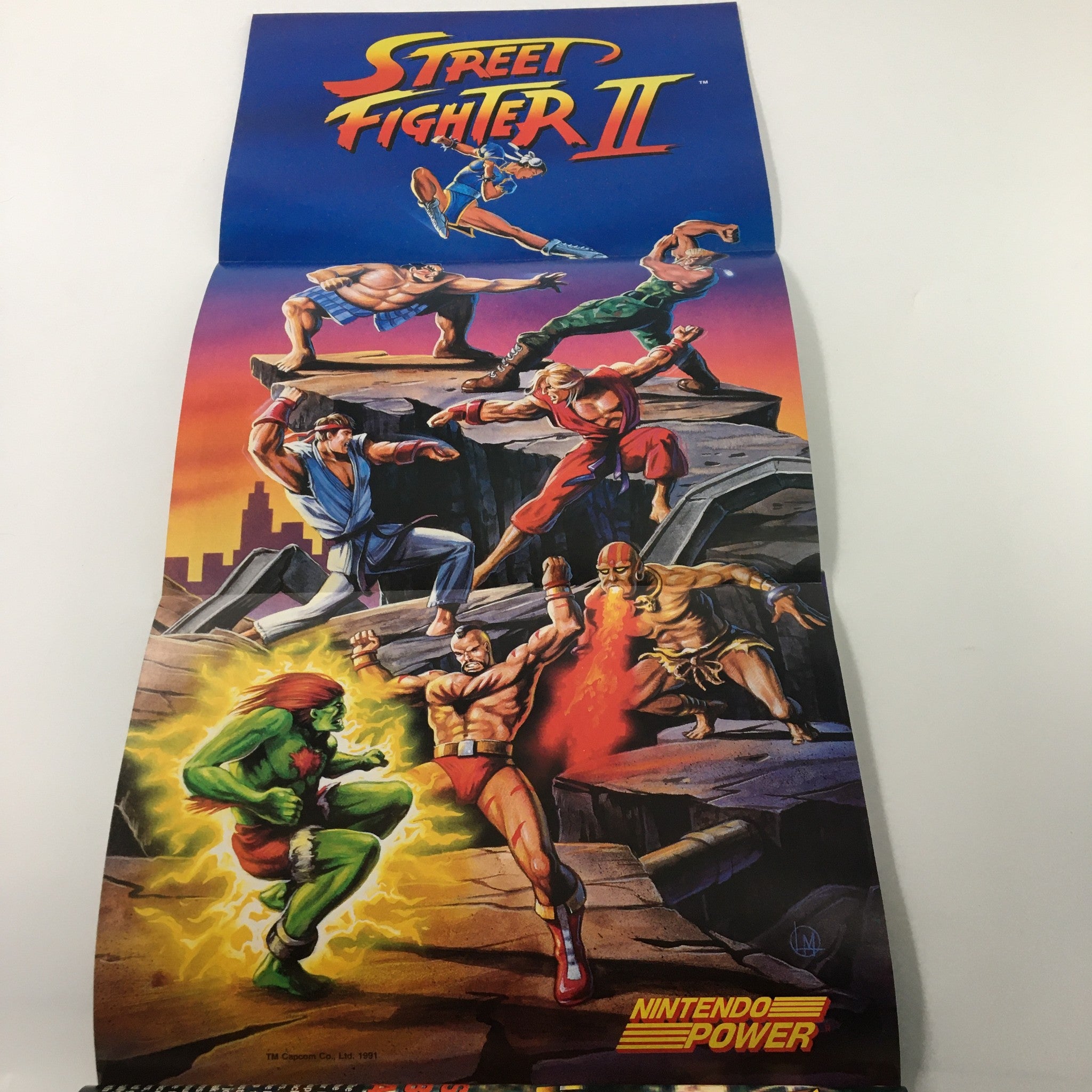 Street Fighter II poster included in Nintendo Power Magazine April 1992 #35, displaying iconic characters in action.