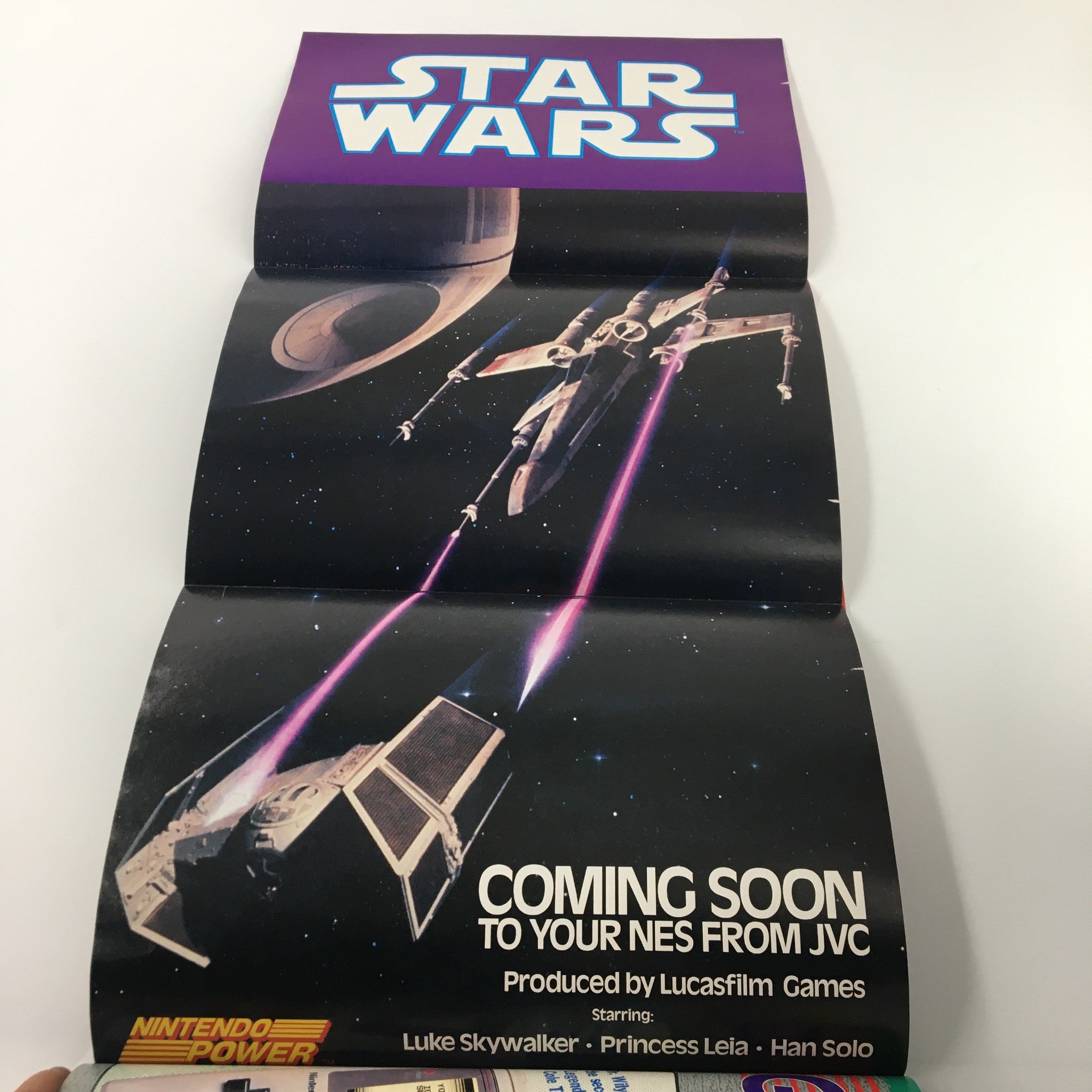 Fold-out poster from Nintendo Power Magazine August 1991 Issue #27 showcasing Star Wars game, highlighting iconic characters and space battle imagery.