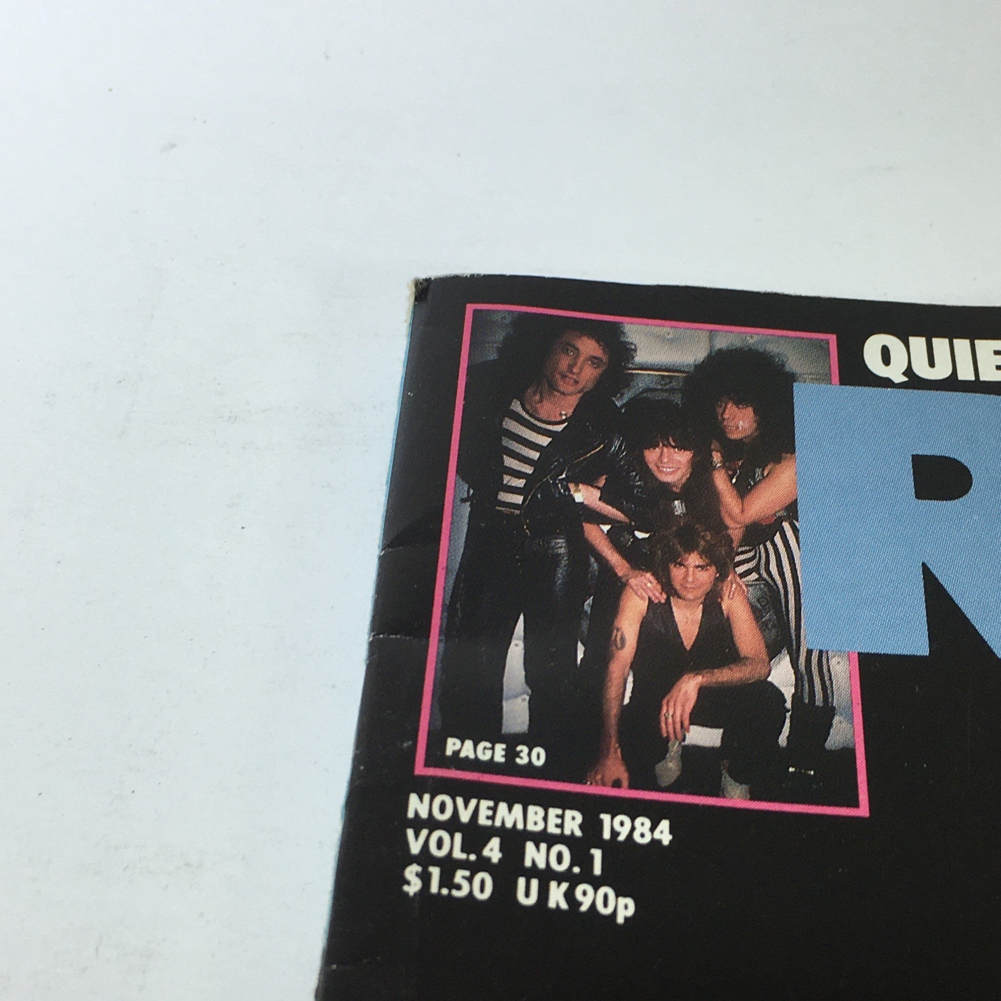 Detail shot of the corner of the November 1984 Record Music Magazine displaying a band photo and publication information. This issue features Lindsey Buckingham and Romeo Void.
