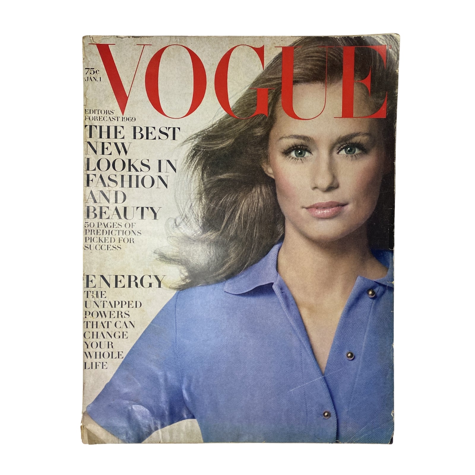 Vogue Magazine January 1, 1969 featuring Lauren Hutton on the cover, showcasing her beauty with soft waves and a blue shirt, highlighting fashion trends of the late 1960s.