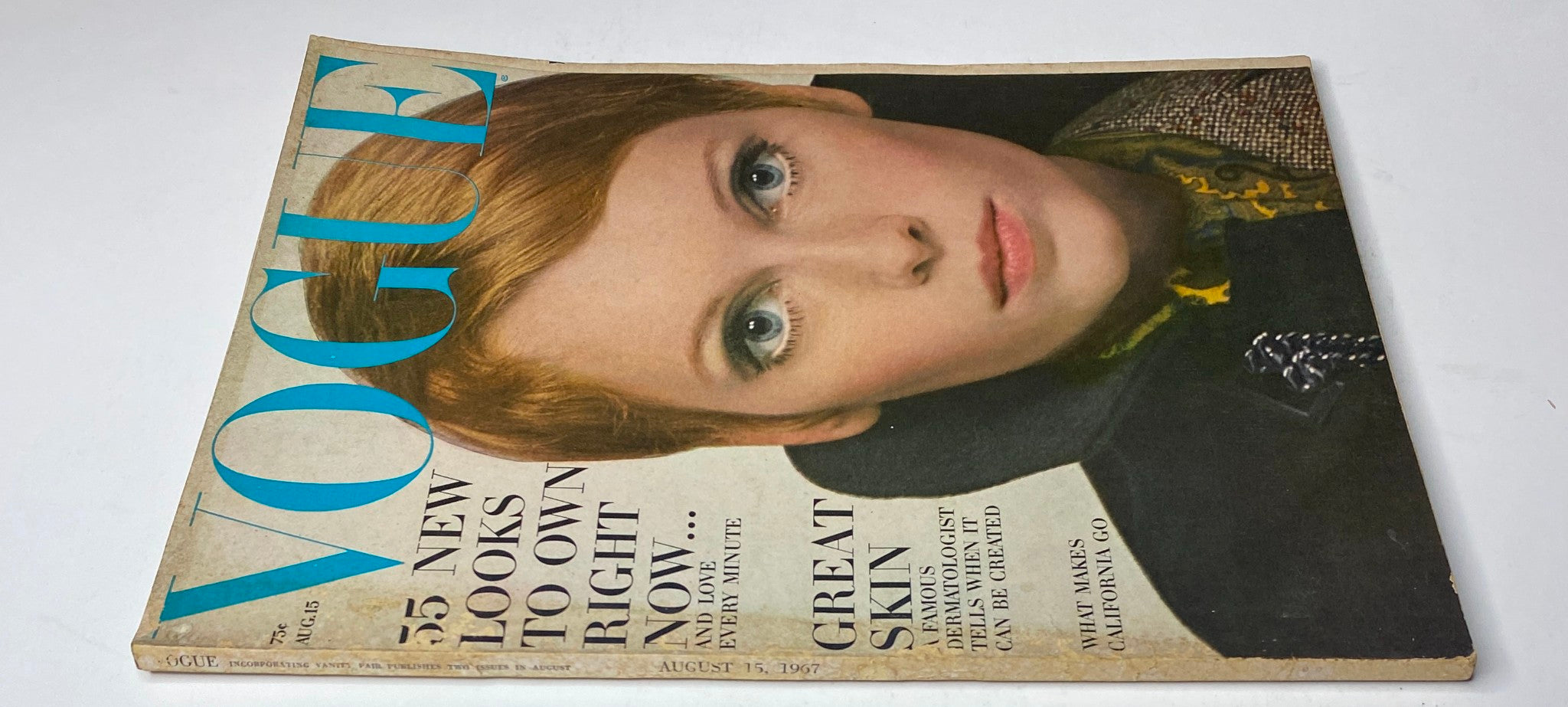 Vogue Magazine August 15, 1967 cover featuring Mia Farrow, showcasing her striking beauty in a matte-black velvet wrap dress photographed by Irving Penn.