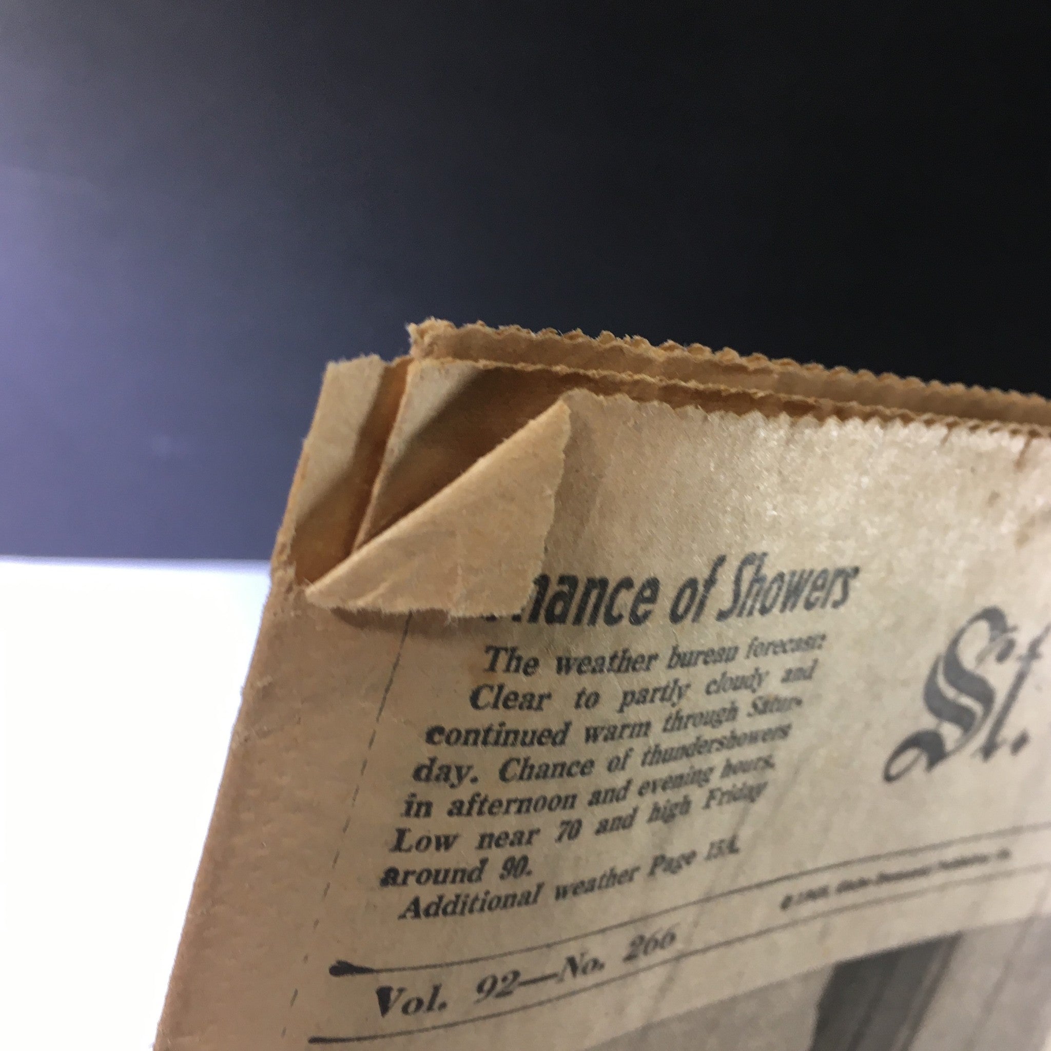 Close-up view of the corner of the VTG St. Louis Globe-Democrat Newspaper from June 7, 1968, highlighting a weather forecast and the vintage paper's aged condition, relevant to the historical context surrounding John and Robert Kennedy.