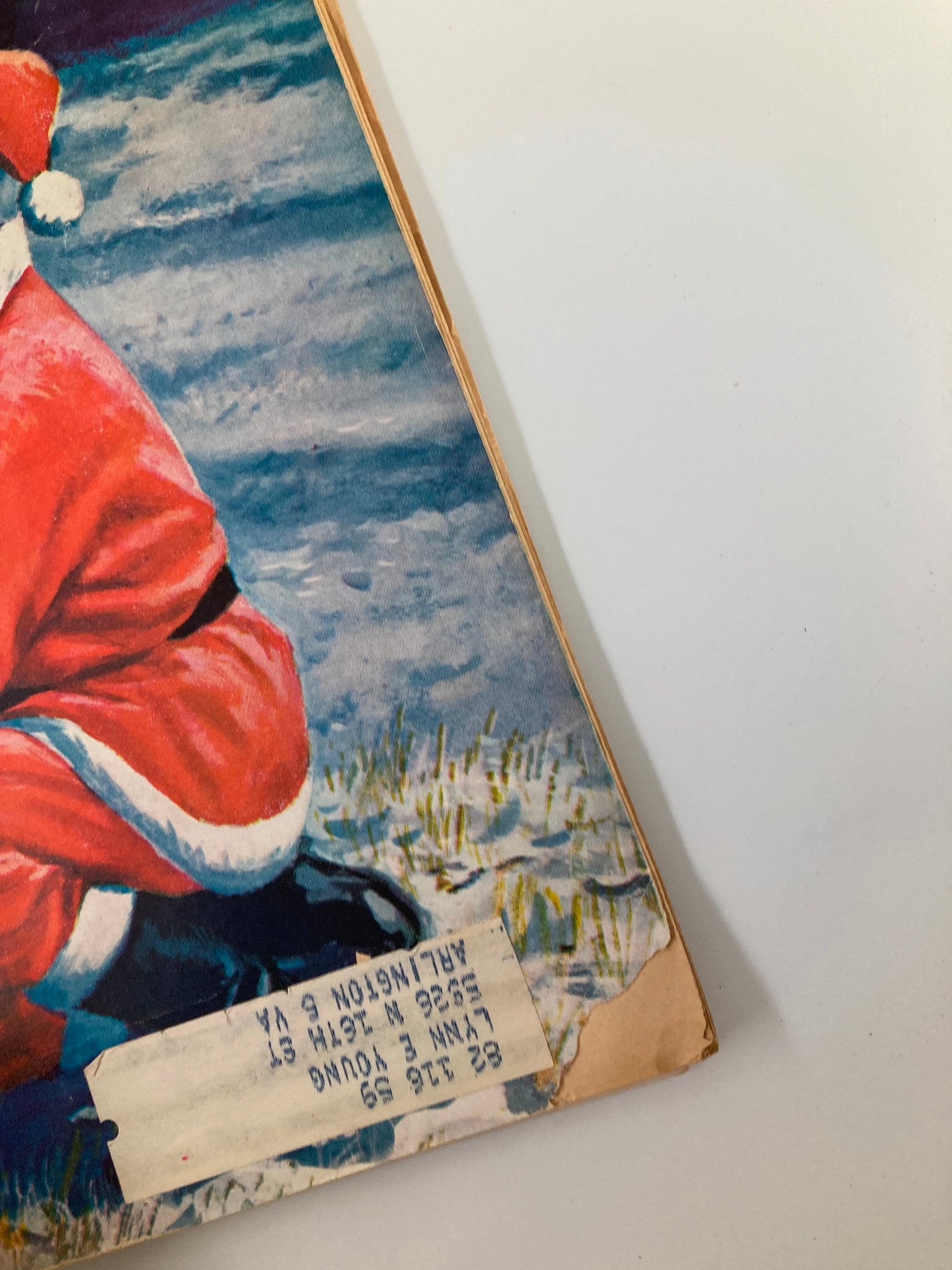 Close-up of the corner of VTG Boys' Life Magazine December 1958, highlighting a Santa character and a label that adds character to this vintage collectible.