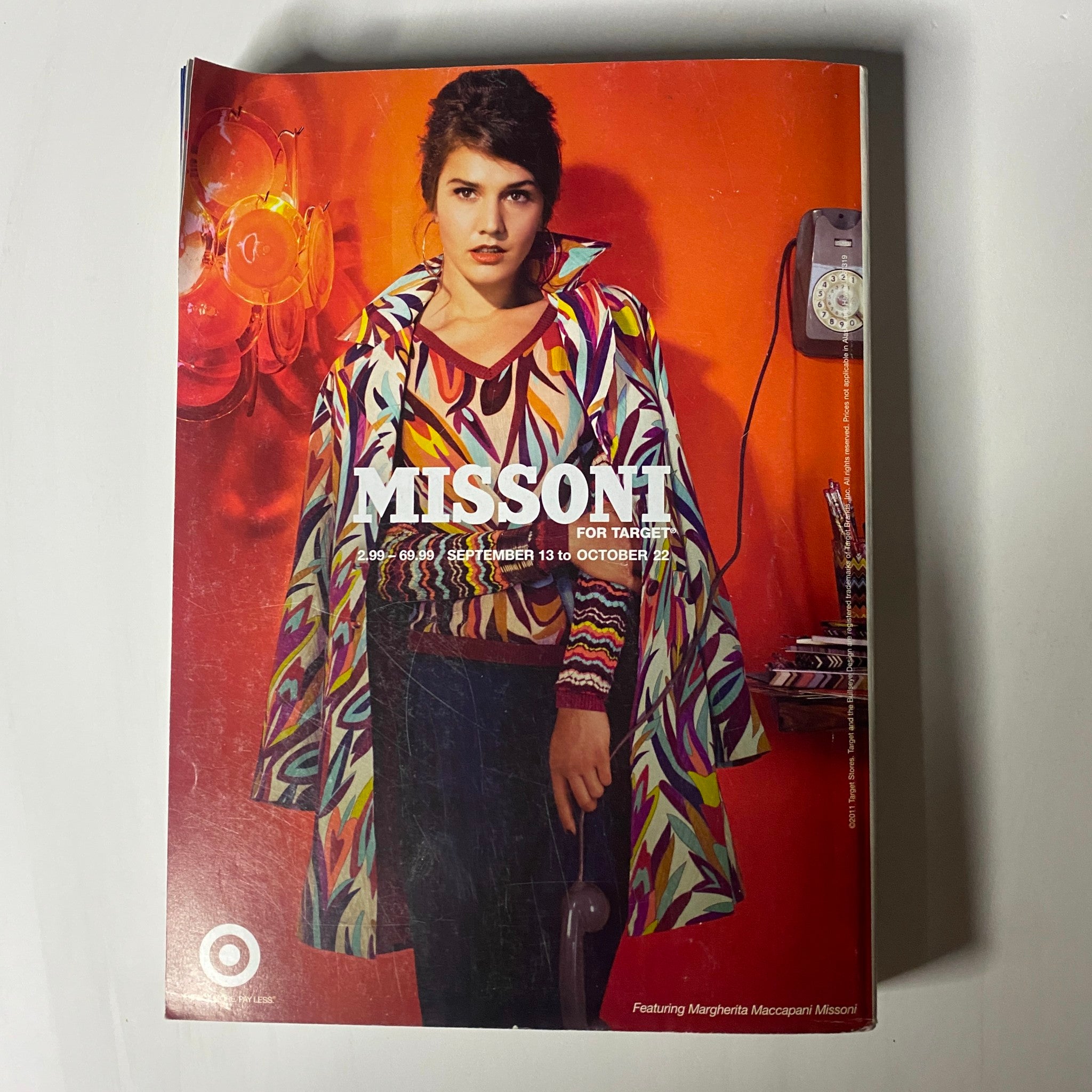 Vogue Magazine September 2011 Kate Moss Cover featuring a model in a retro Missoni for Target outfit against a striking red background, capturing the colorful essence of the brand.