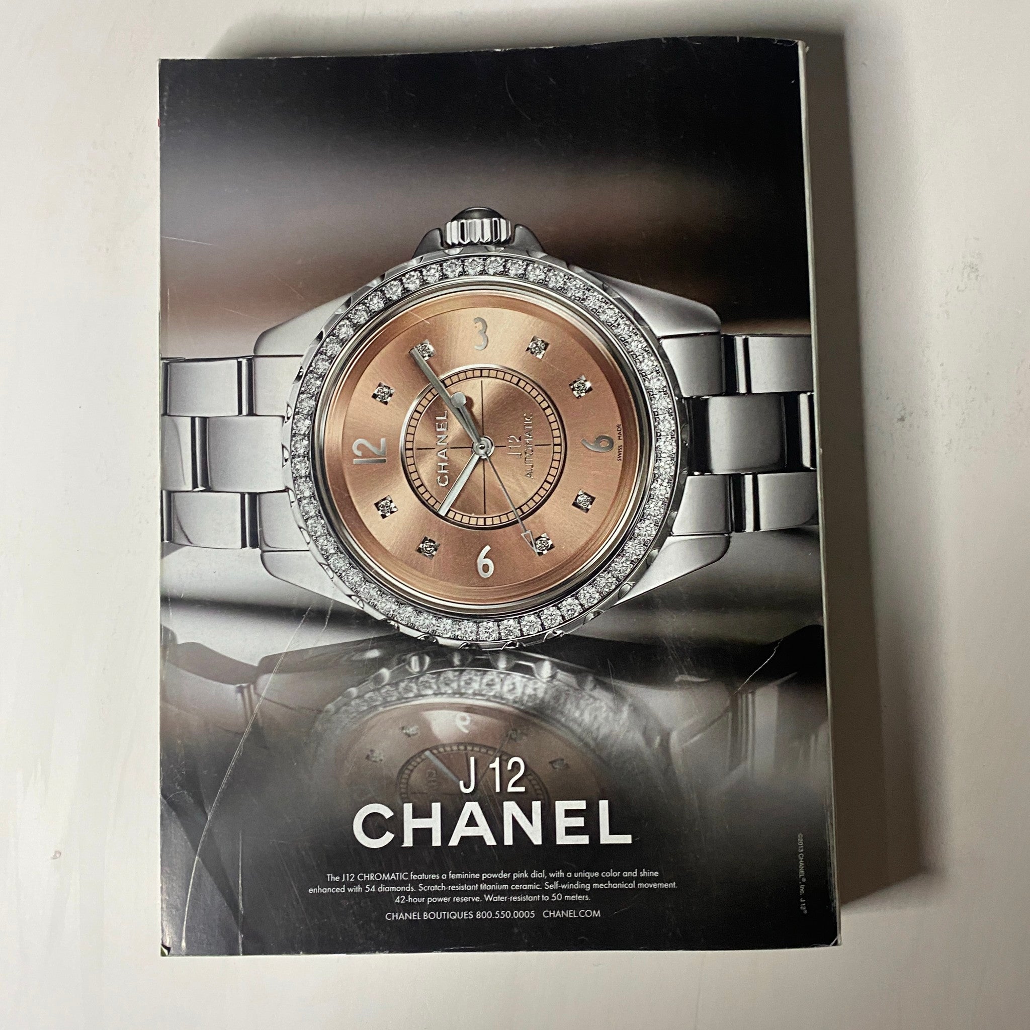 Vogue Magazine March 2013 showcasing a luxurious Chanel J12 watch with a rose gold face and diamond accents, highlighting its elegance and sophistication.