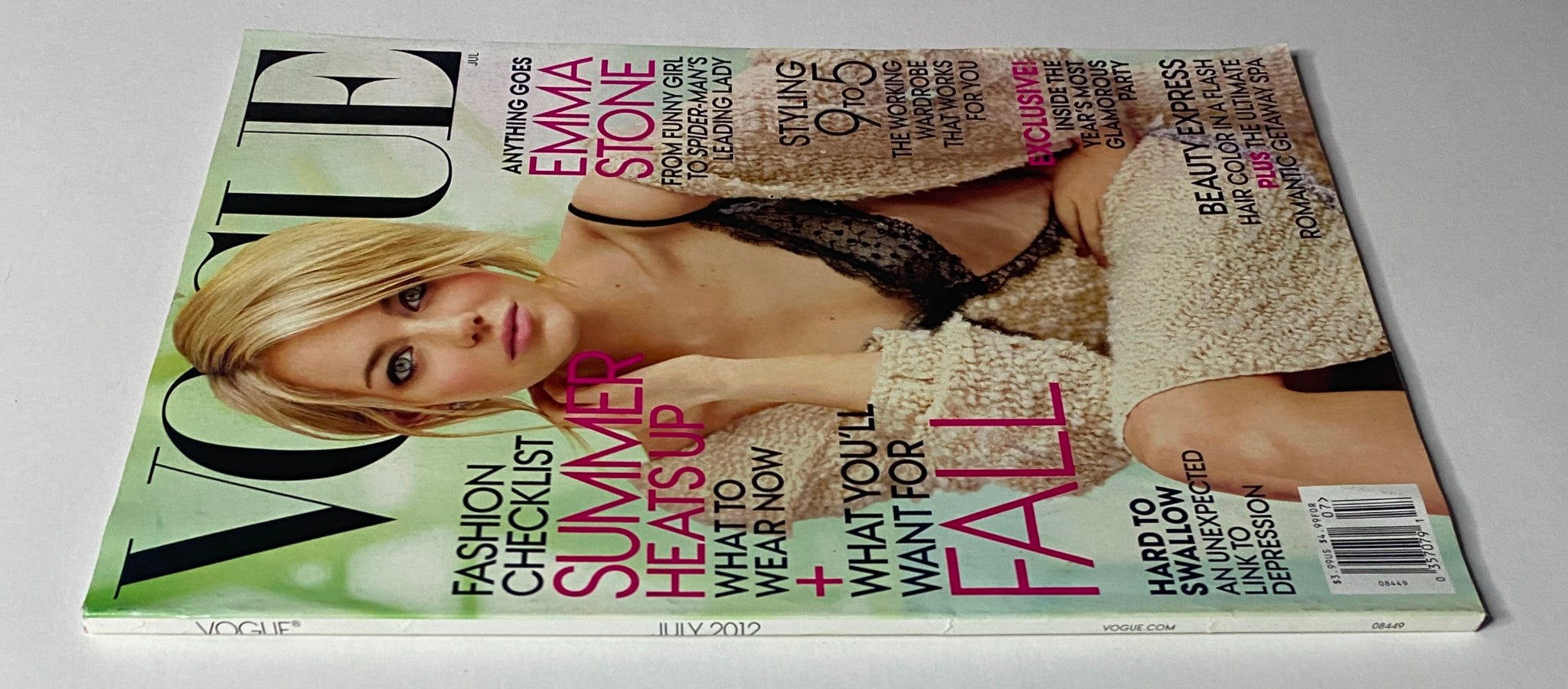 Vogue Magazine July 2012 featuring Emma Stone, emphasizing summer fashion trends and styling tips for fall. The magazine showcases a chic cover image of Emma Stone in elegant attire.
