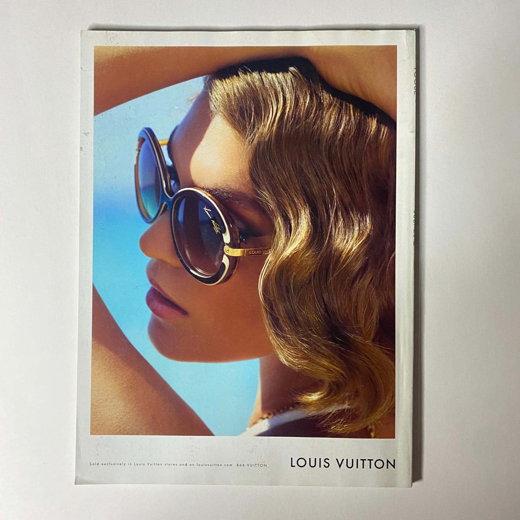 Vogue Magazine July 2012 Emma Stone Cover No Label VG, displaying an advertisement for Louis Vuitton sunglasses, highlighting glamorous summer style.
