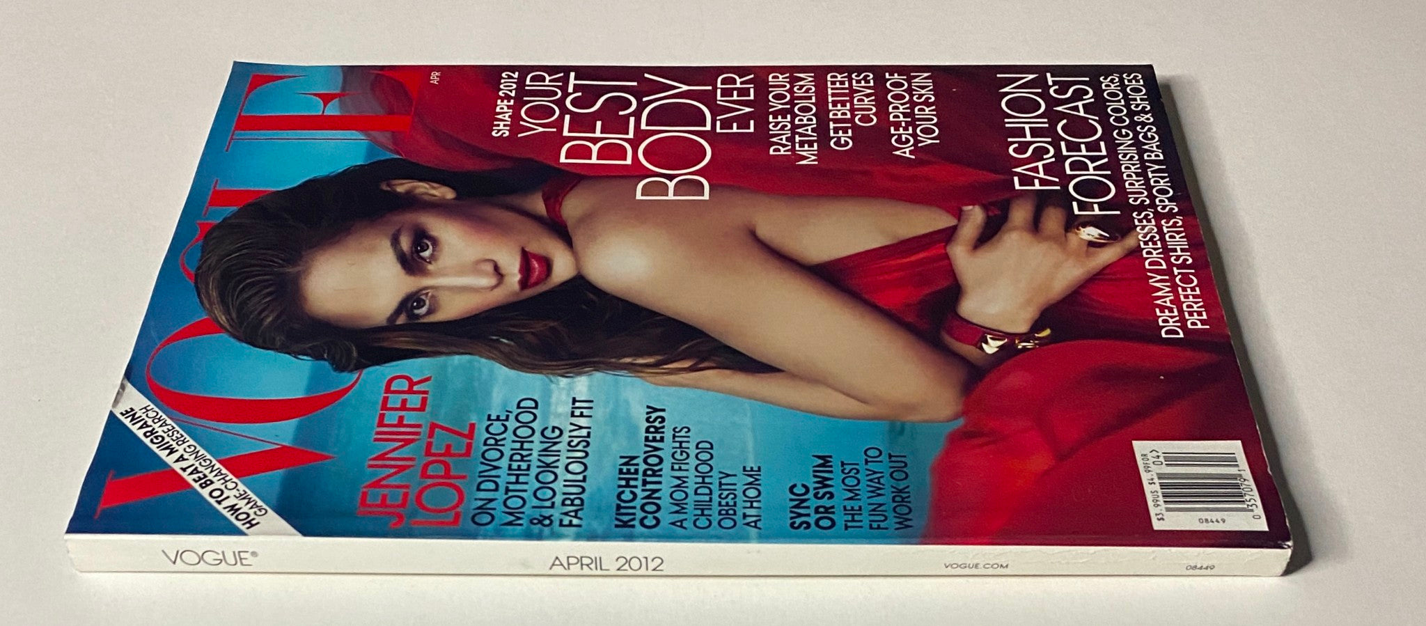 Side view of Vogue Magazine April 2012 with Jennifer Lopez on the cover, emphasizing her iconic fashion style and the magazine's content on fitness and lifestyle.