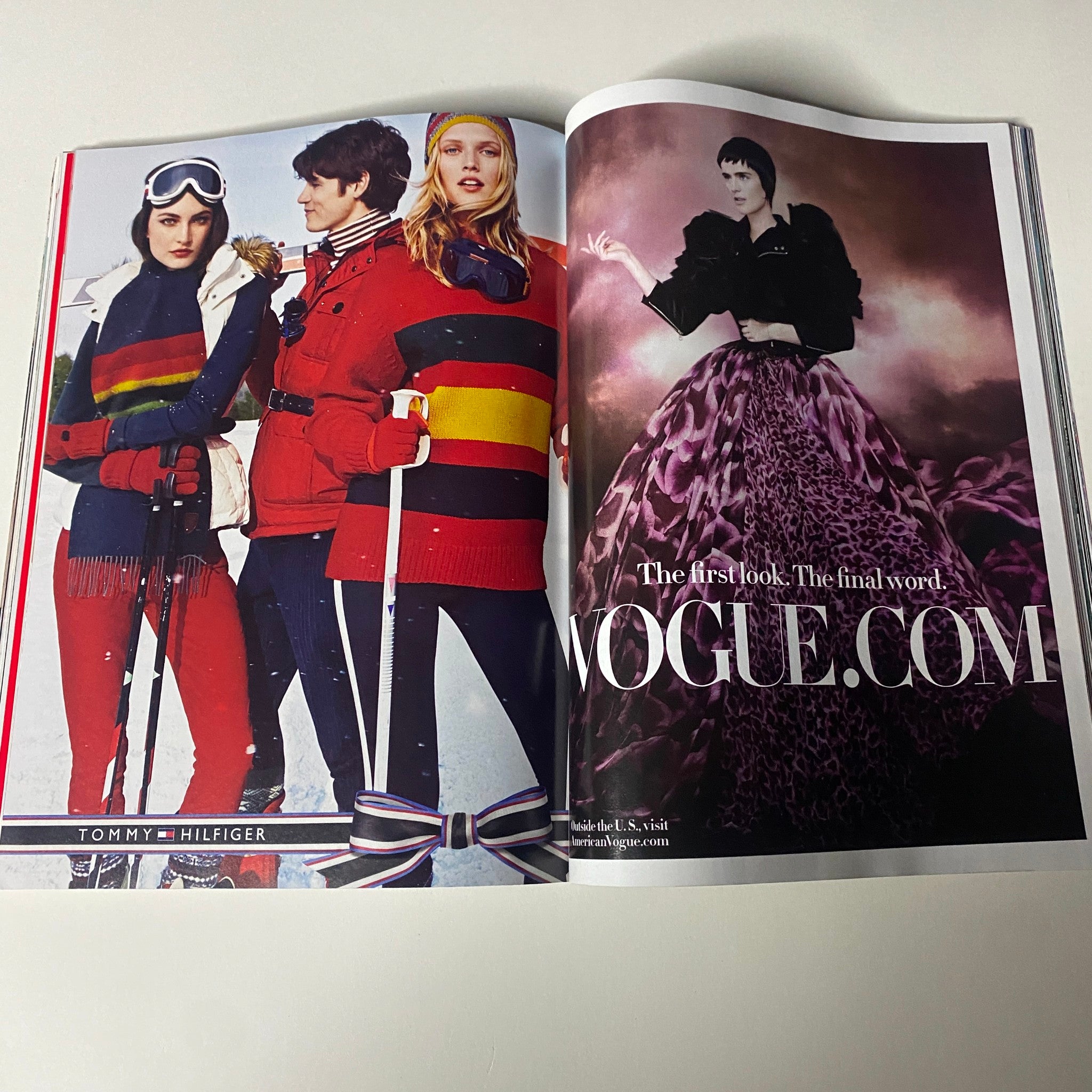 Vogue Magazine December 2012 Anne Hathaway Cover showcasing a fashion editorial spread with models dressed in winter attire by Tommy Hilfiger, emphasizing vibrant colors and styles.