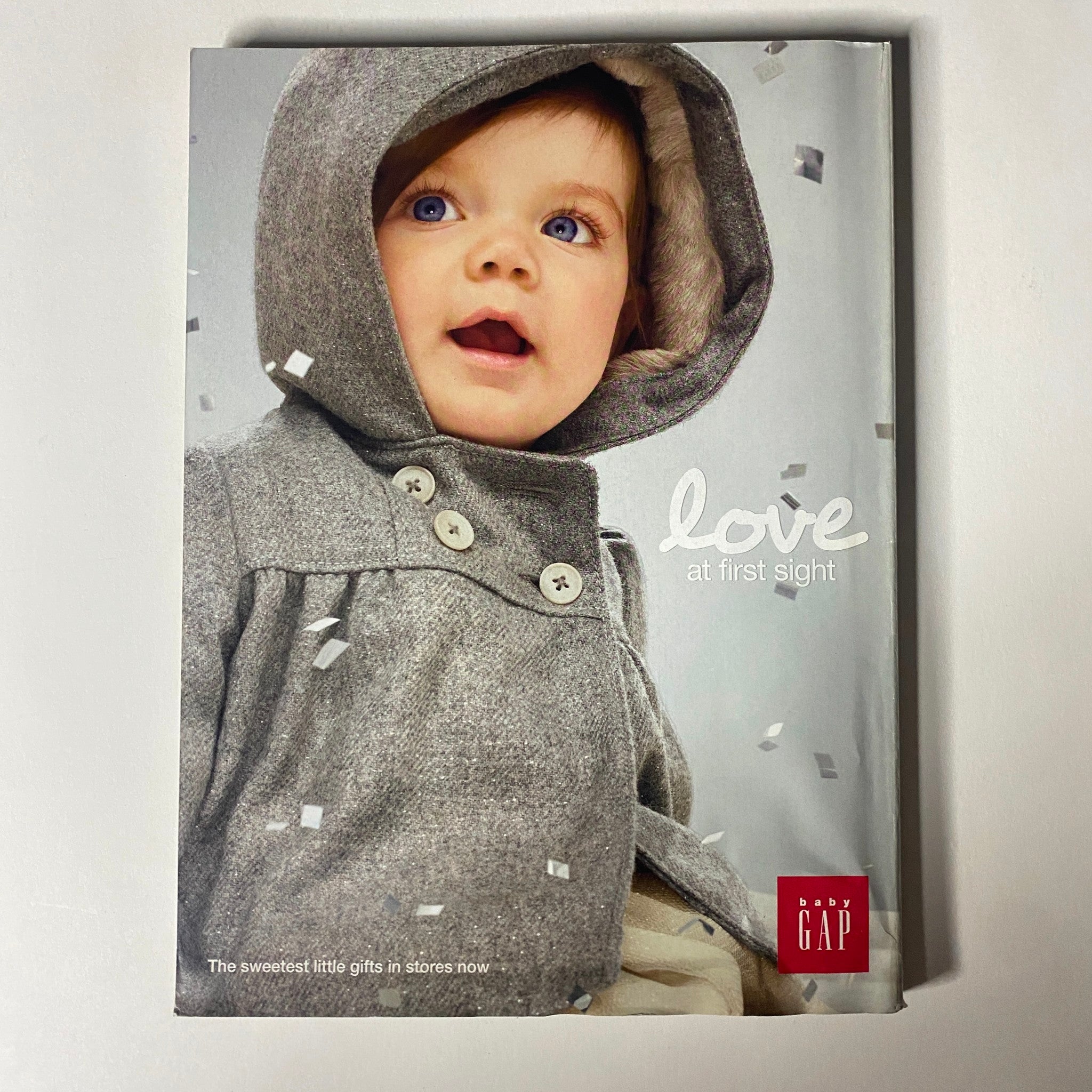Vogue Magazine December 2012 Anne Hathaway Cover featuring an advertisement for GAP showcasing a child in a cozy winter outfit, highlighting seasonal gift ideas.