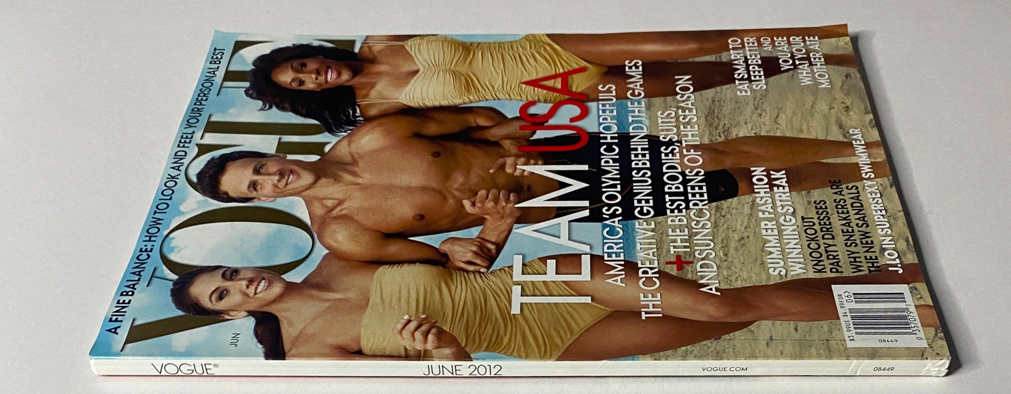Close-up of the side view of Vogue Magazine June 2012, showcasing the vibrant cover featuring Team USA Olympic athletes Hope Solo, Ryan Lochte, and Serena Williams in stylish swimsuits.