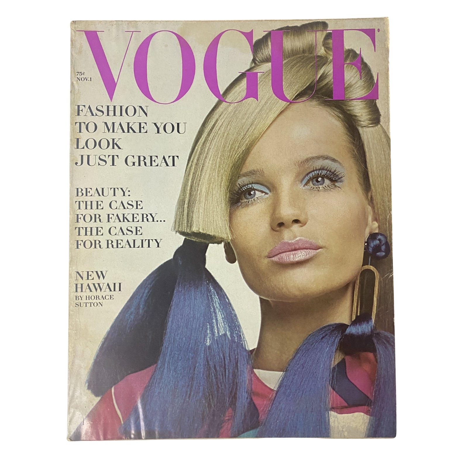 Vogue Magazine November 1, 1966 cover featuring striking model with long hair and bold makeup, showcasing a vintage fashion aesthetic.