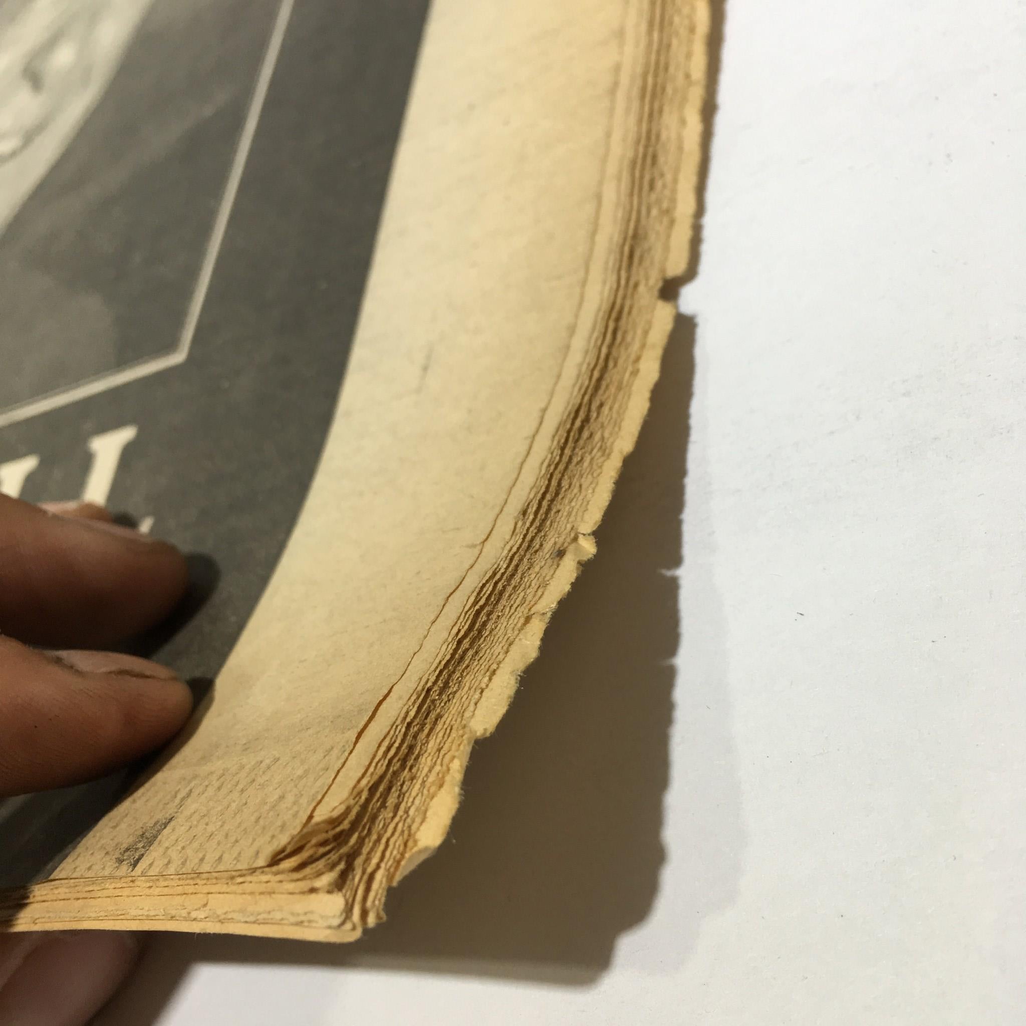 Close-up of the edge of the November 6, 1991 NY Daily News, showing worn pages for the tribute to Robert Maxwell, 1923-1991.