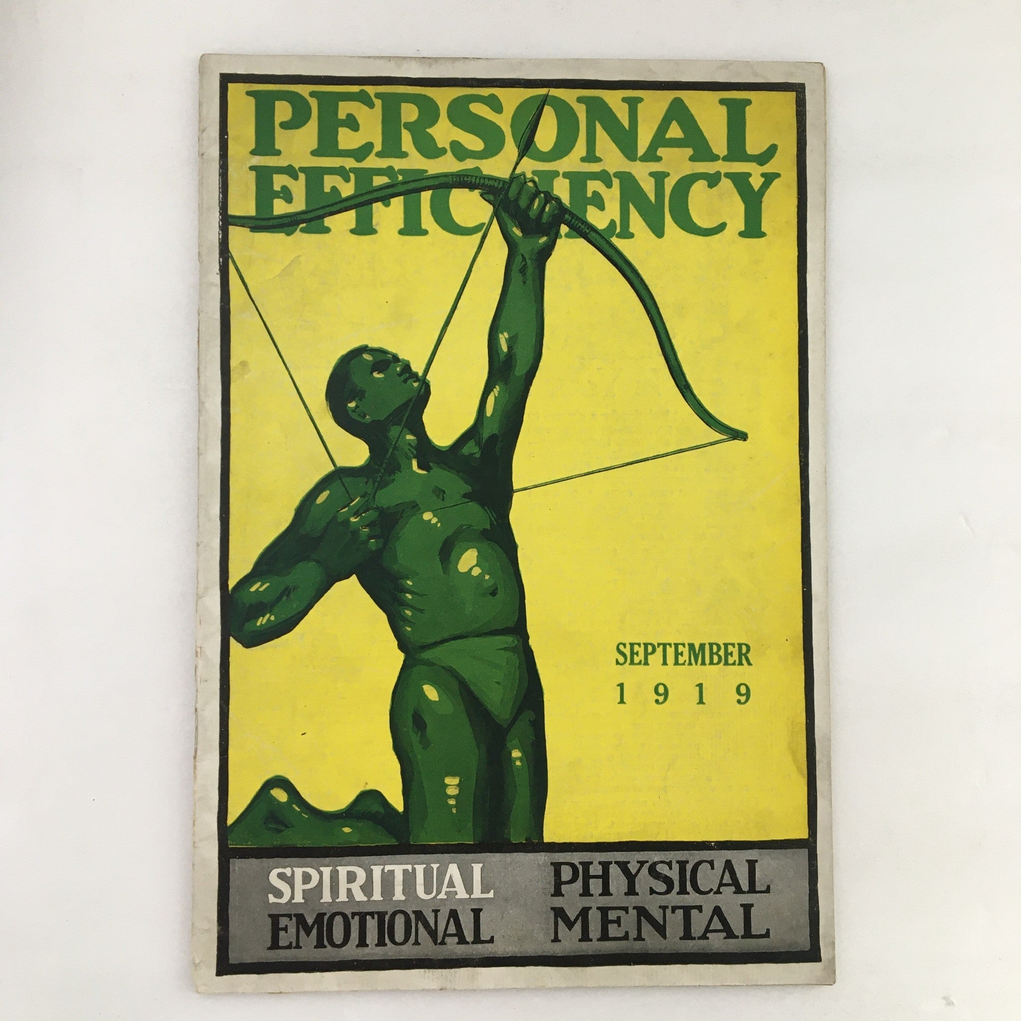 Cover of Personal Efficiency Magazine from September 1919 featuring a green figure aiming an arrow, representing personal development themes.