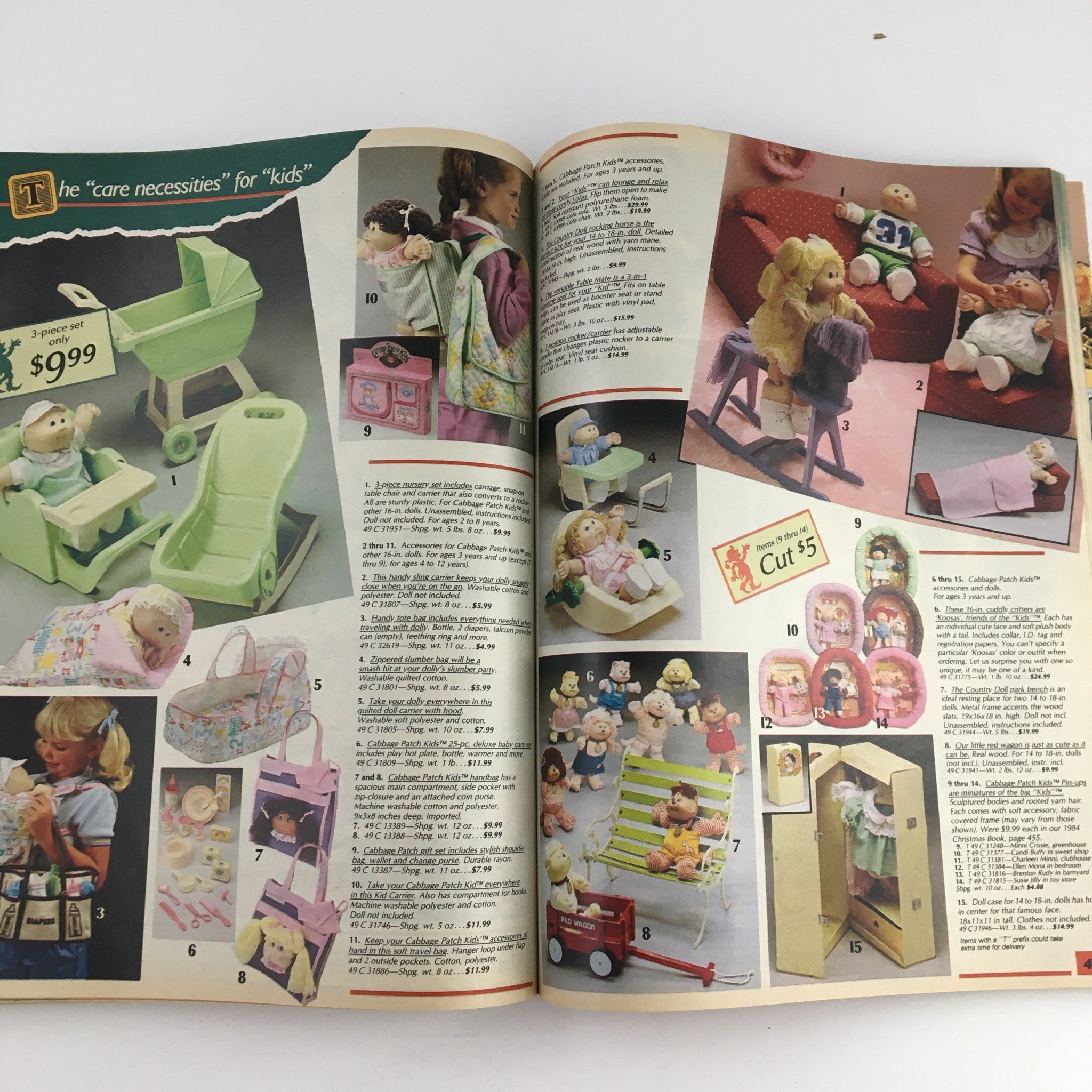 1985 Sears Wish Book Care Bear Cousins Price Guide Catalog highlighting 'Care Necessities' for kids, featuring a green baby stroller set and various Cabbage Patch Kids accessories, with prices listed.