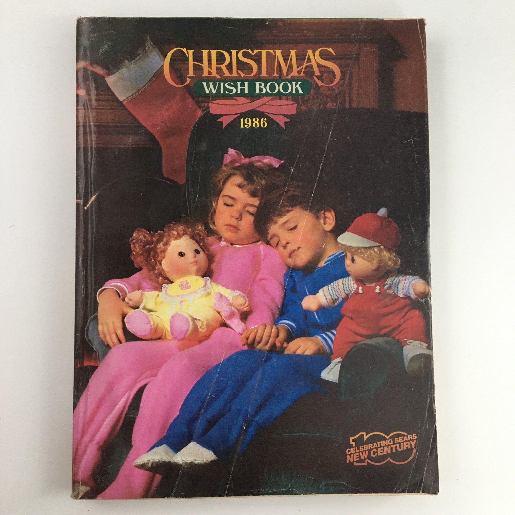 1986 Sears Wish Book For Kids Barbie Toy Catalog cover featuring two children asleep with their dolls, showcasing the nostalgic holiday spirit.