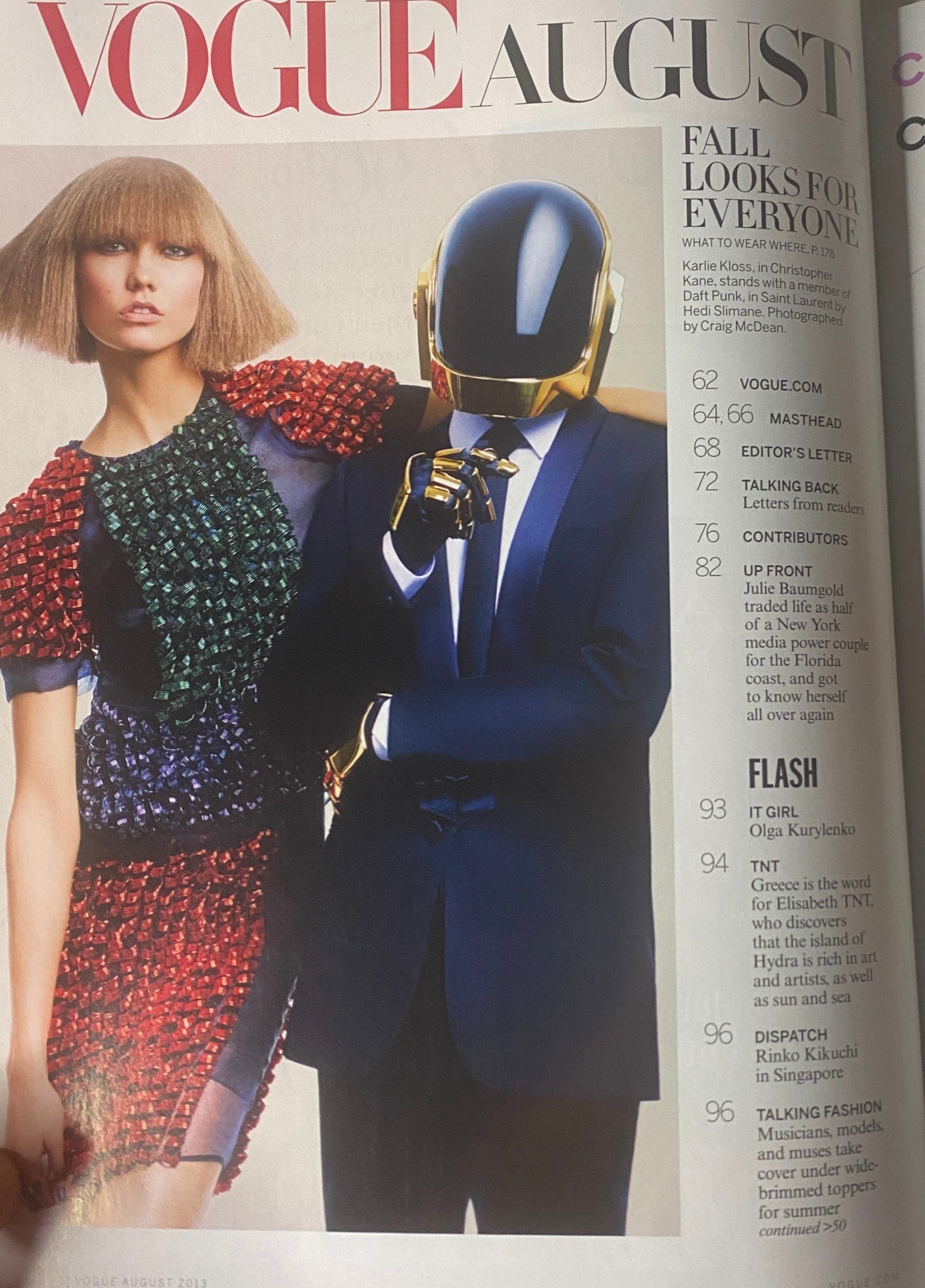 Interior page of Vogue Magazine August 2013 showcasing various fashion features including an edgy photo of a model in colorful attire and creative headwear.