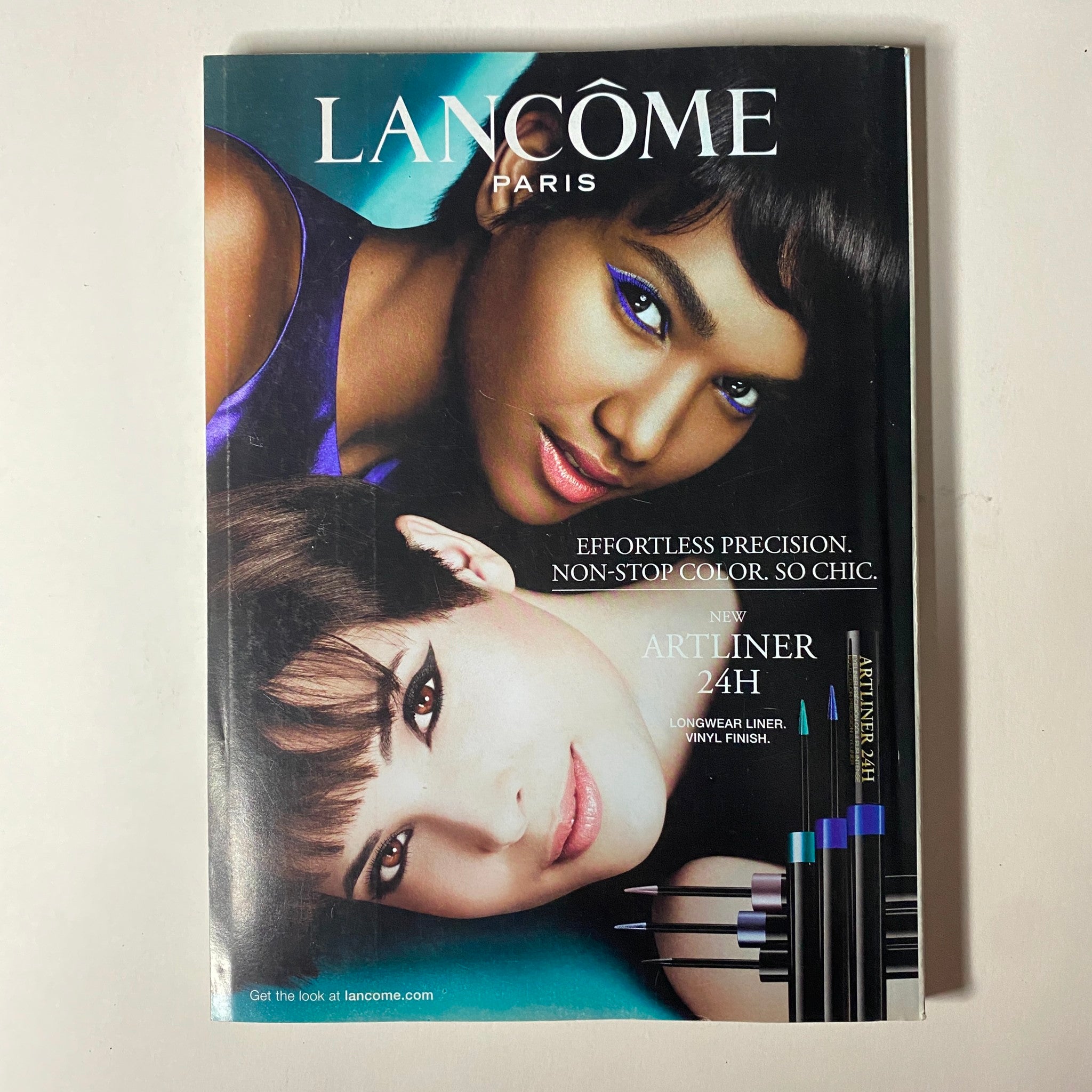 Vogue Magazine October 2013 Sandra Bullock Cover featuring a Lancome advertisement highlighting beauty products with models displaying makeup artistry, enhancing the magazine’s beauty theme.