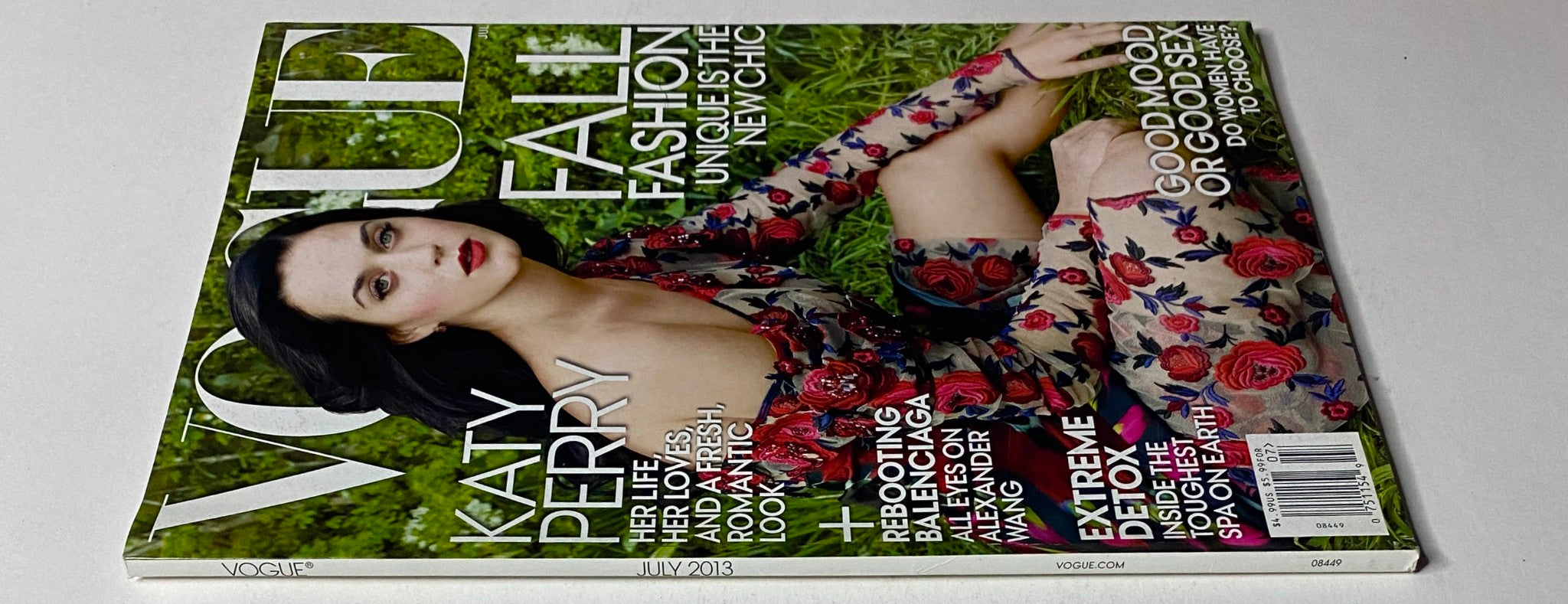 Side view of Vogue Magazine July 2013 featuring Katy Perry on the cover, emphasizing the vivid floral design and magazine details.