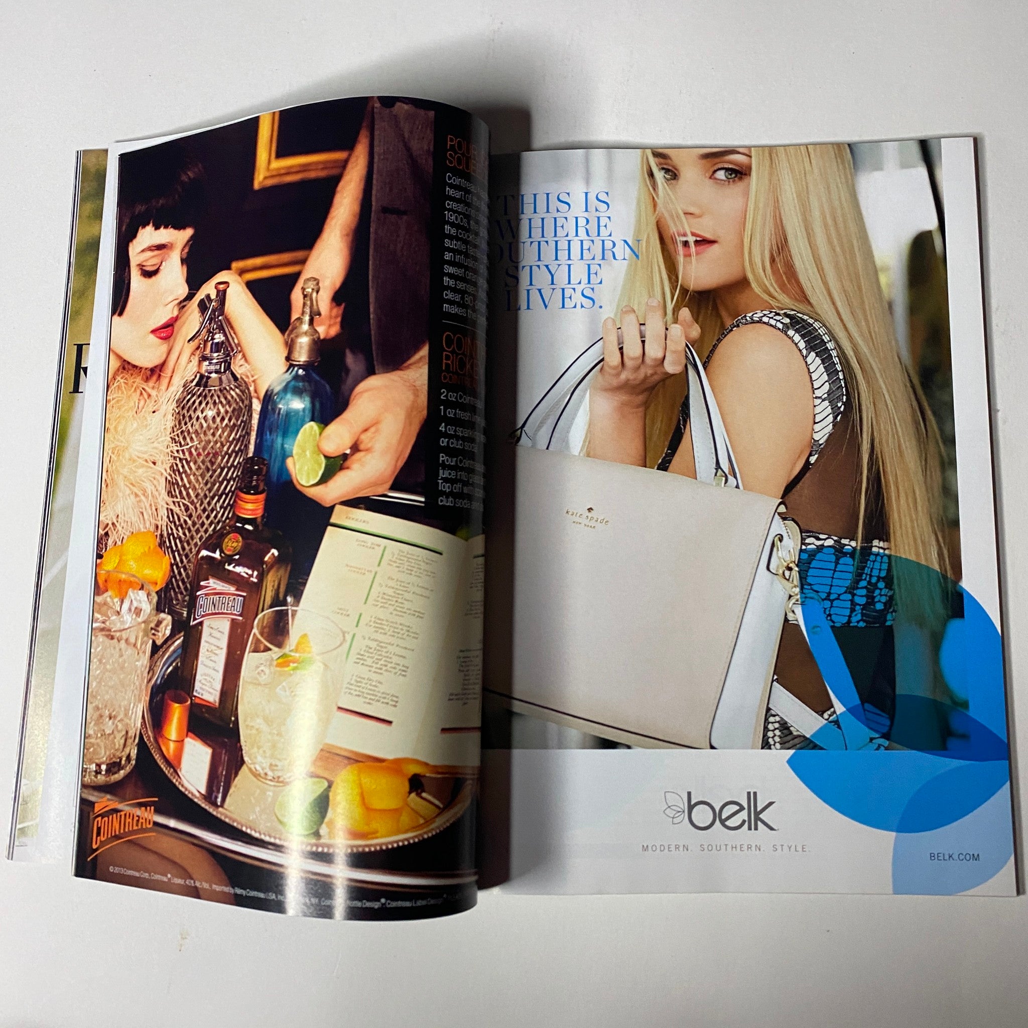An advertisement spread from Vogue Magazine July 2013 displaying a glamorous pub scene with cocktails and a stylish woman holding a handbag, showcasing modern southern style.